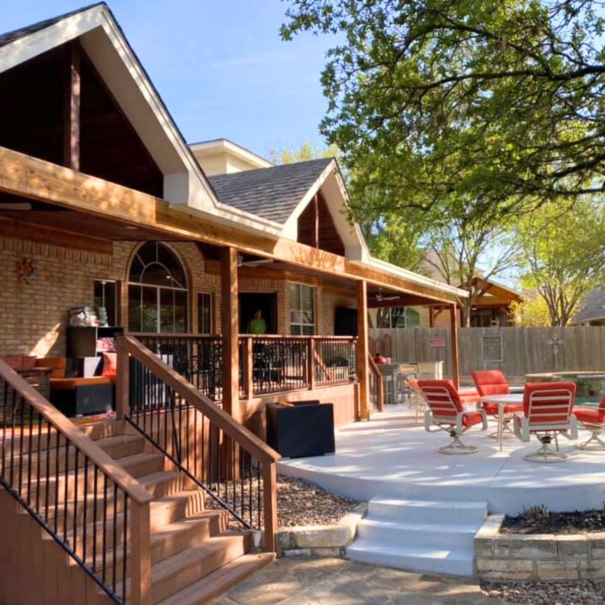 After: Austin backyard transformation featuring custom stone outdoor kitchen and grill