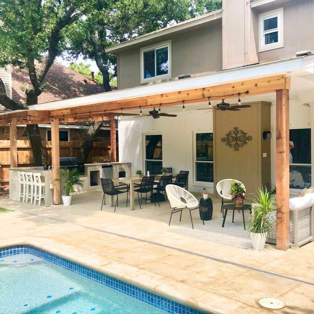 After: custom Austin outdoor kitchen with built-in grill, stone island, and pergola