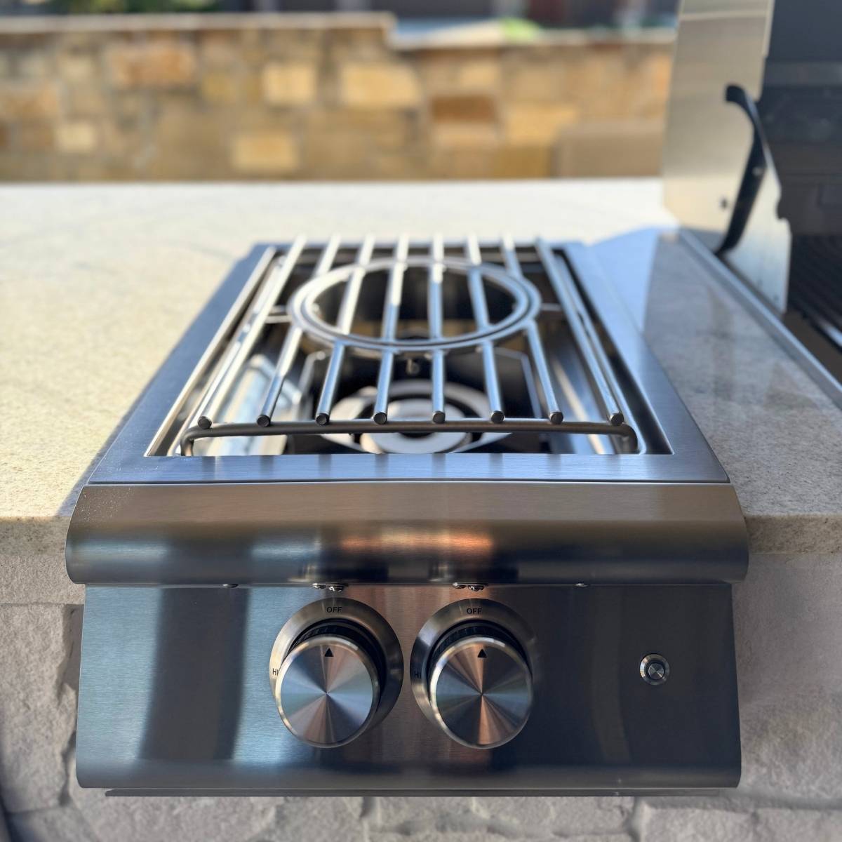After: Austin outdoor kitchen remodel with stone counters and stainless appliances