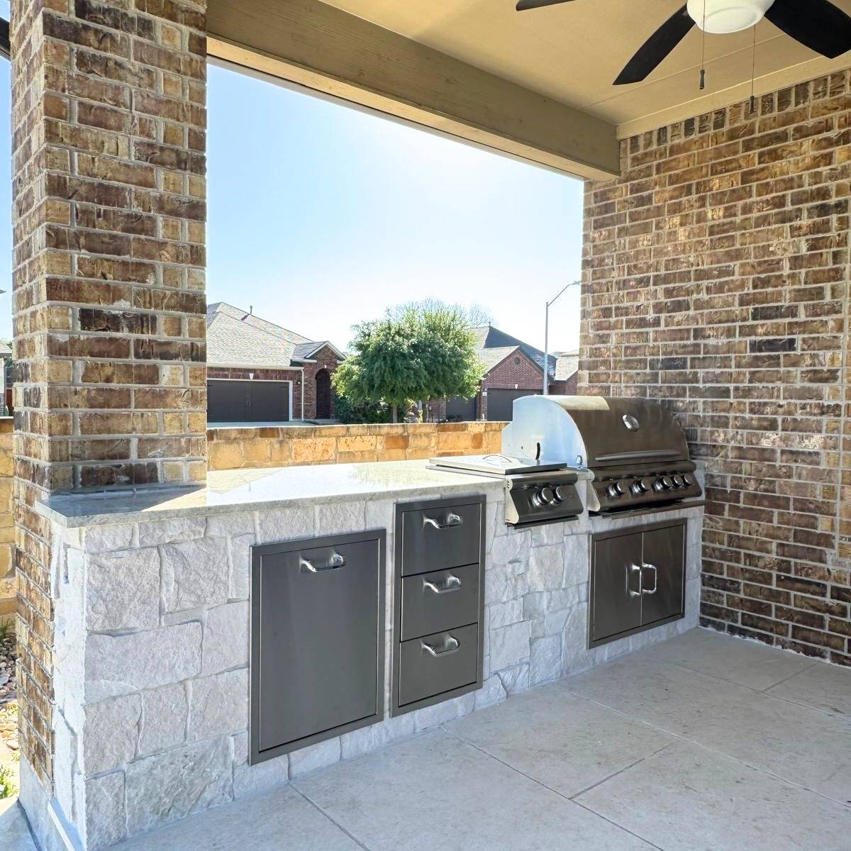After: family-friendly covered Austin outdoor kitchen with built-in grill