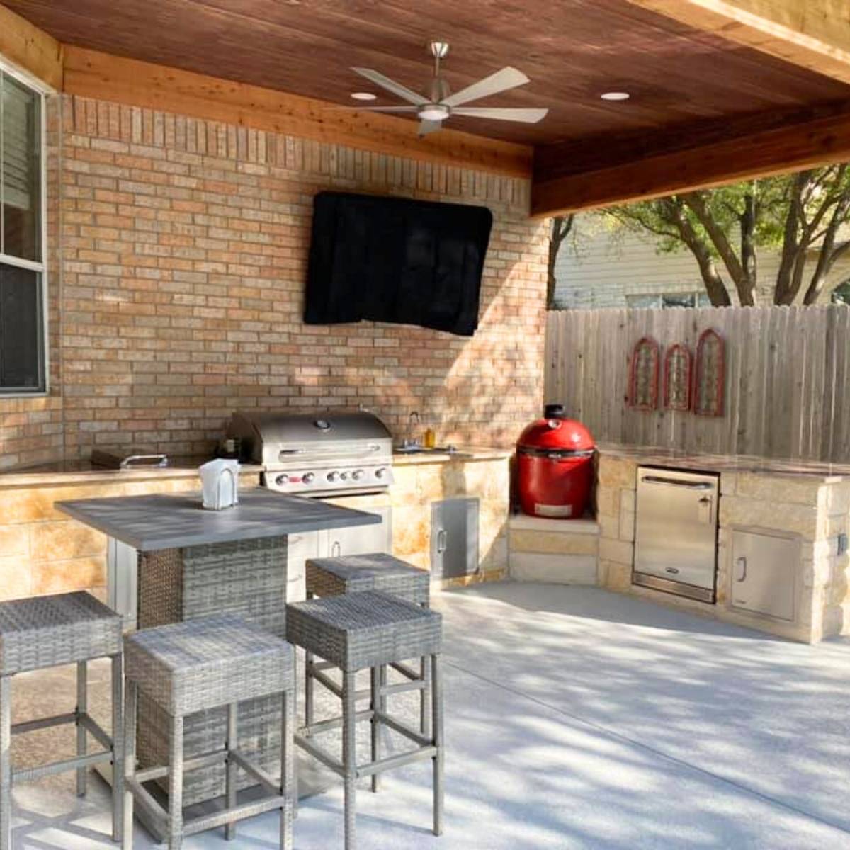 After: custom covered Austin outdoor kitchen with built-in grill, and stone island,