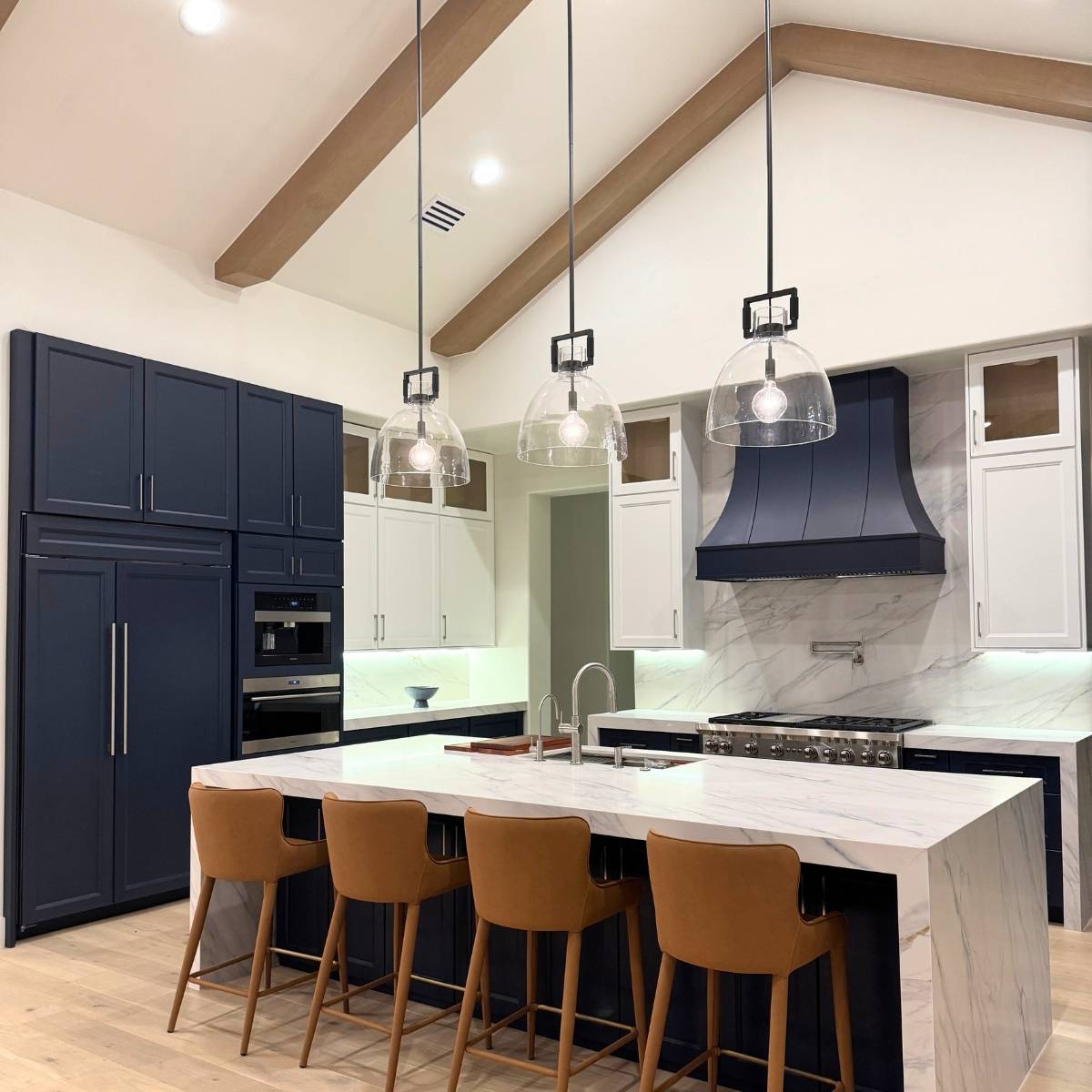 After: Luxury Austin TX kitchen remodel - custom cabinetry, waterfall countertop, and LED lighting