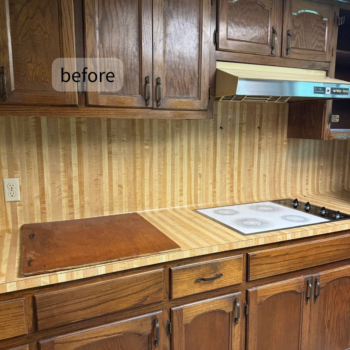 Before: 1970s Austin kitchen before transformation - dark wood cabinets and wallpaper backsplash
