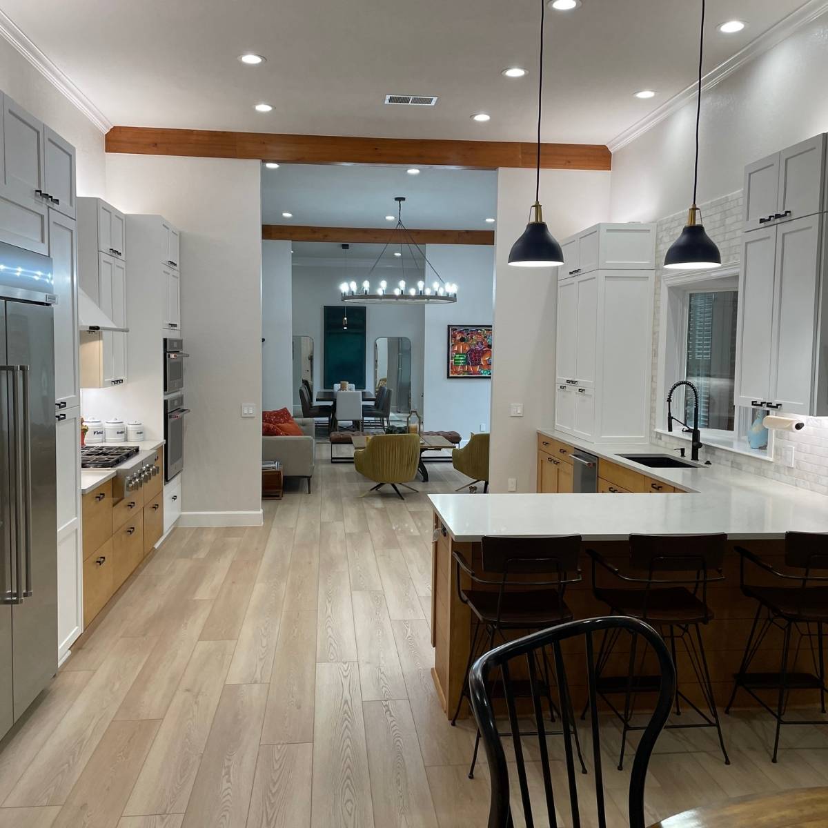 After: Open concept Austin kitchen with wood beams that opens up to the living area space 