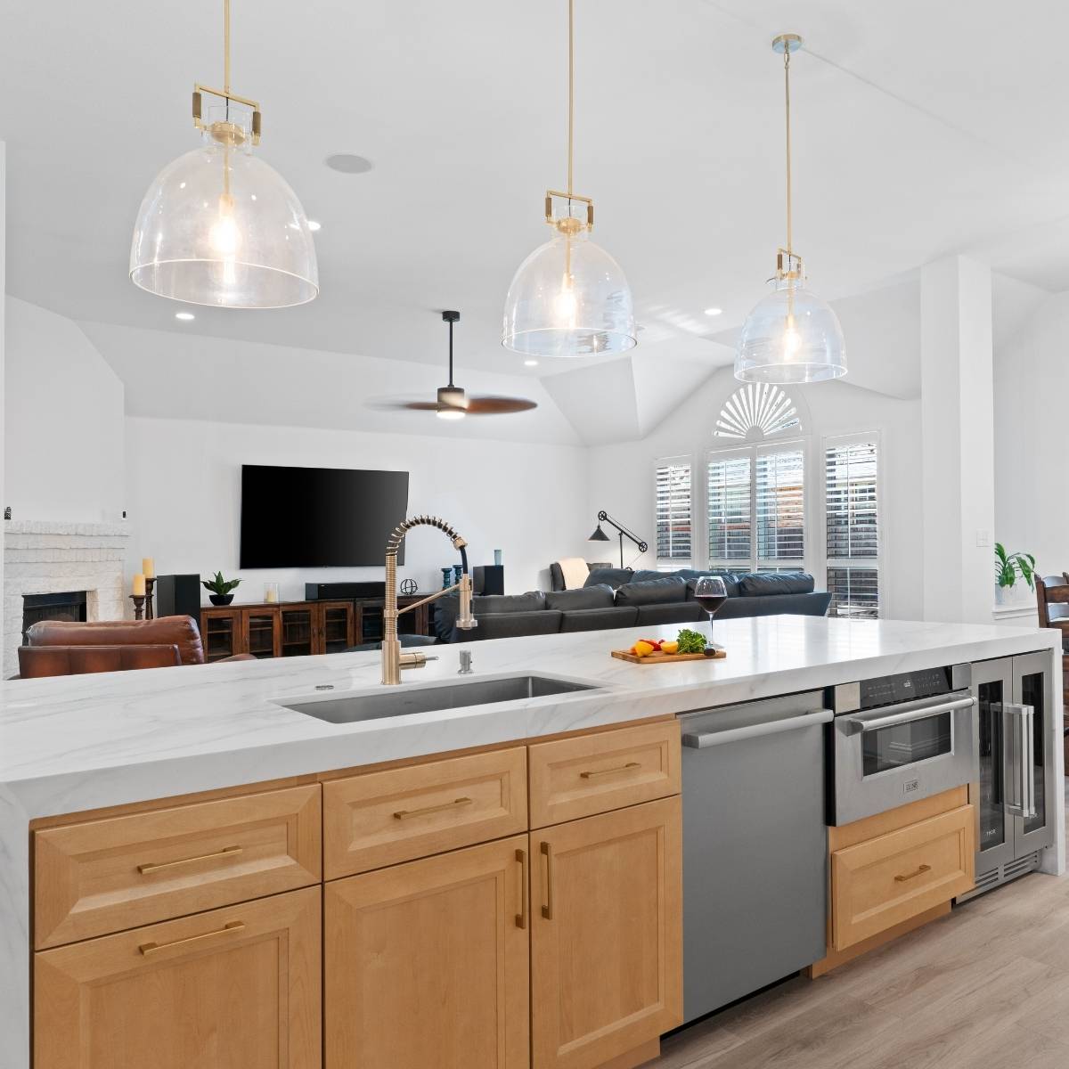 After: Open concept Austin kitchen transformation with custom island with wine fridge