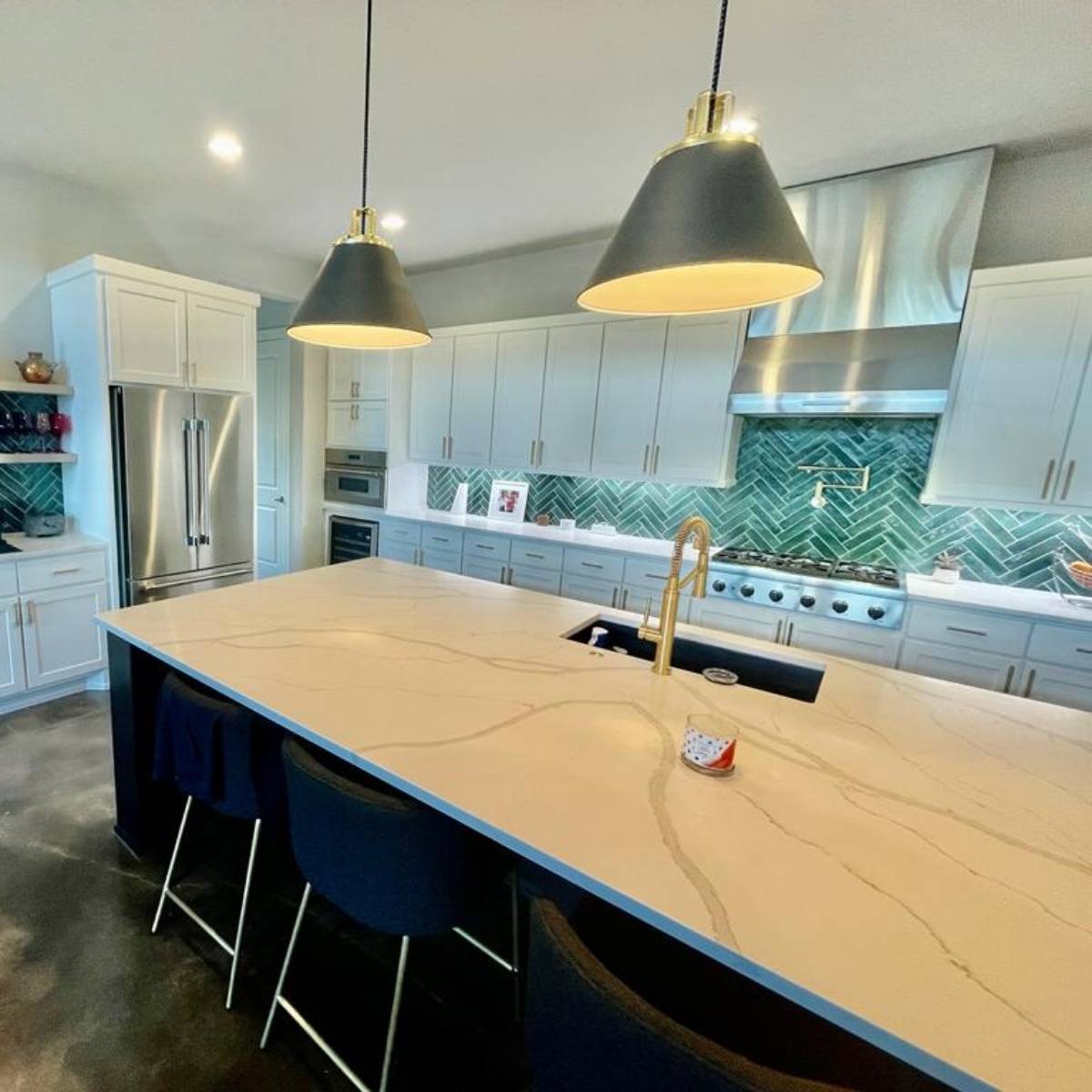 After: modern Austin kitchen renovation - modern blue cabinets and custom herringbone backsplash