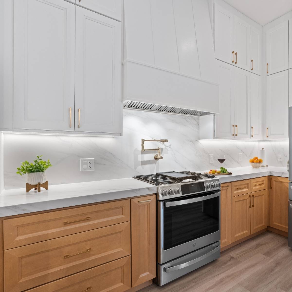 After: Open concept Austin kitchen transformation with custom hood vent and stainless appliances