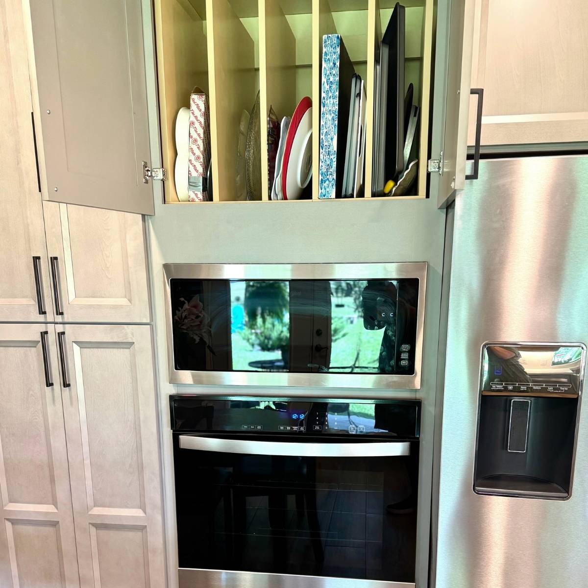 After: Contemporary Austin kitchen by ATX Custom Remodel featuring pull out cabinet drawers for organization
