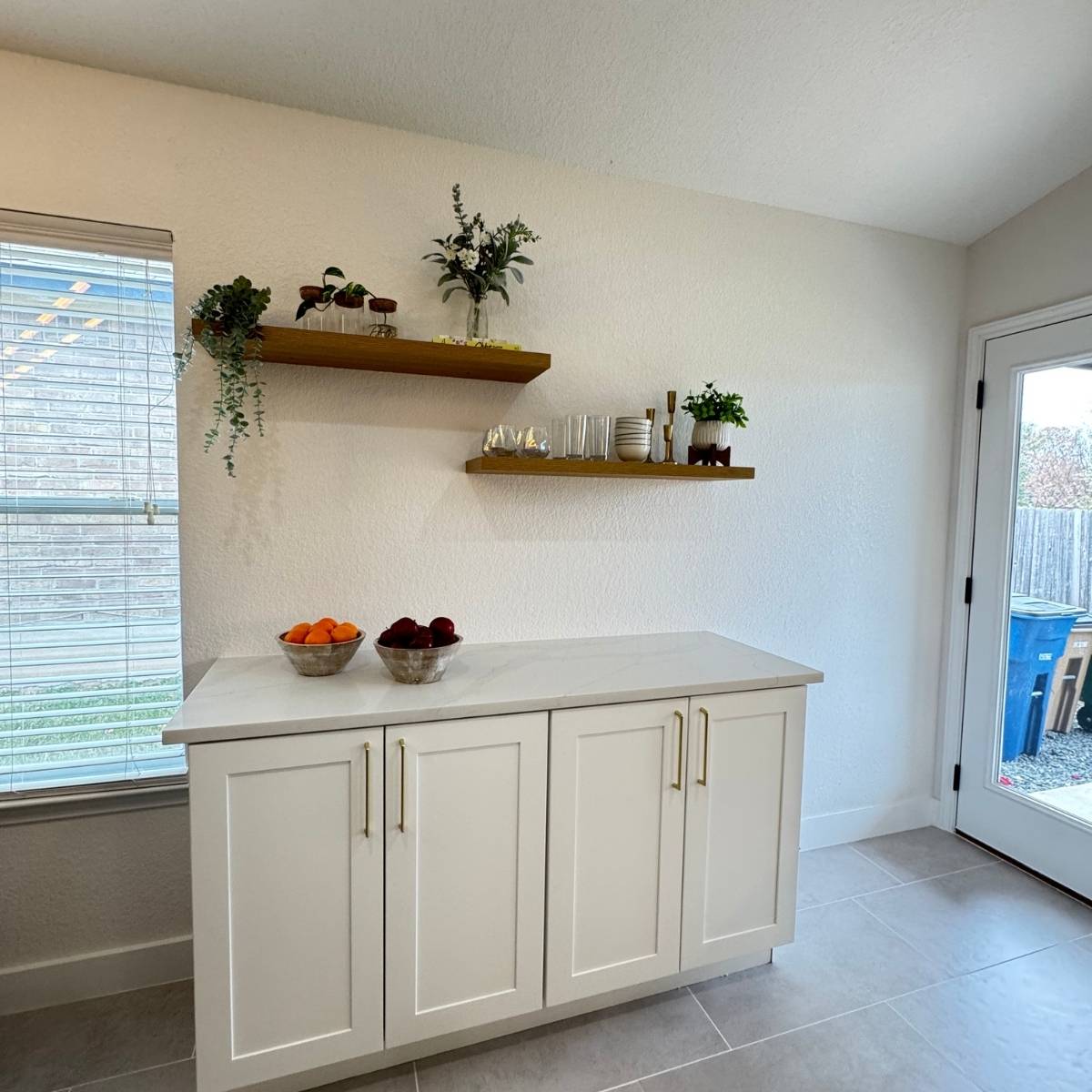 After: Open concept Austin kitchen transformation with floating shelves, stainless appliances and white cabinets