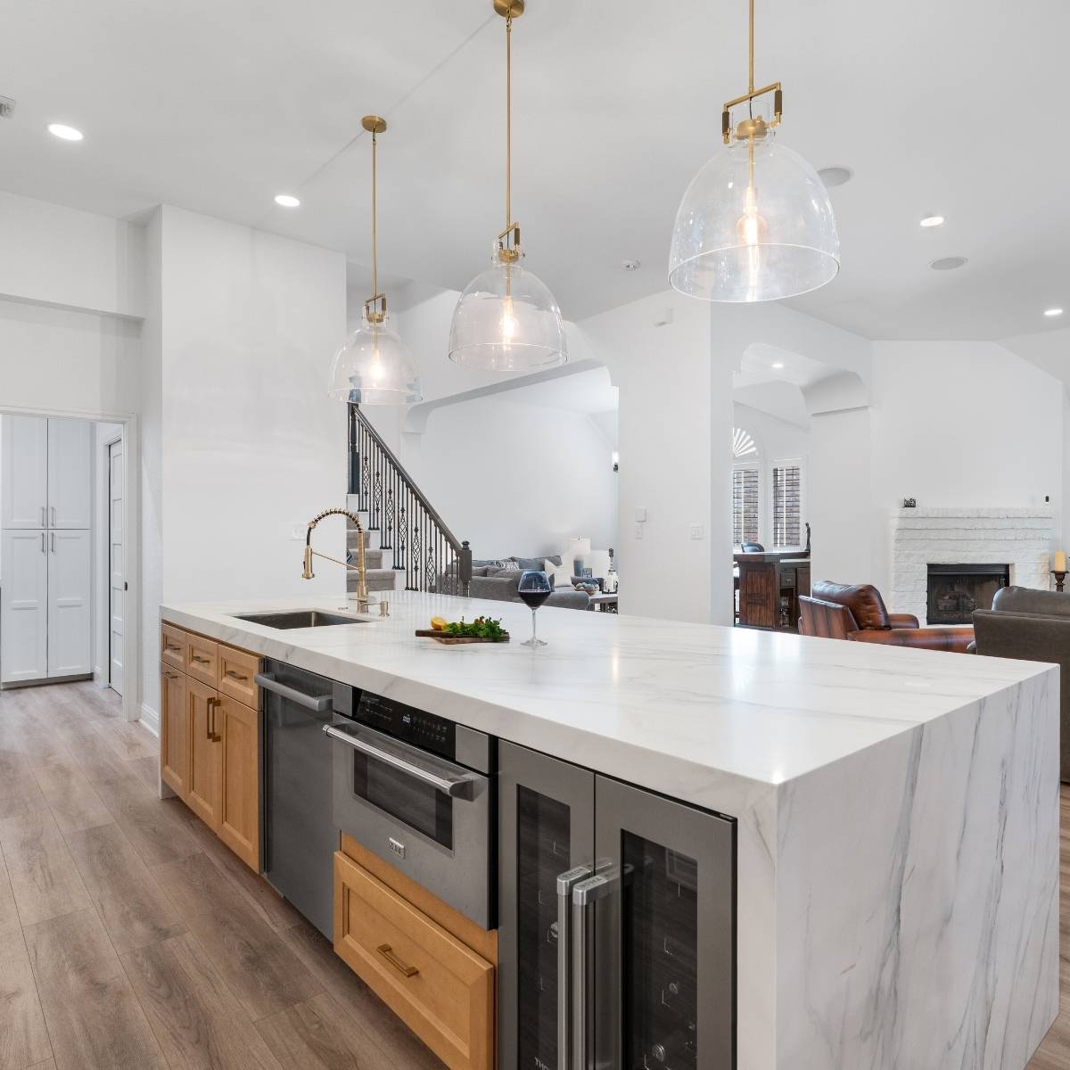 After: Open concept Austin kitchen transformation with waterfall counters and stainless appliances
