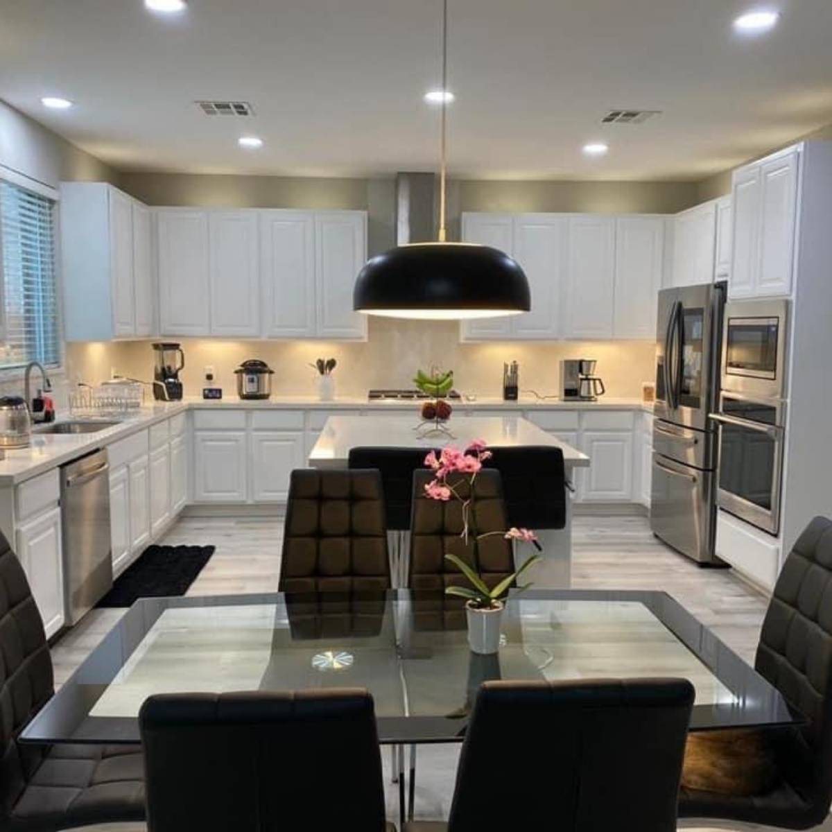 After: Modern Austin kitchen remodel by ATX Custom Remodel - white cabinets and quartz island