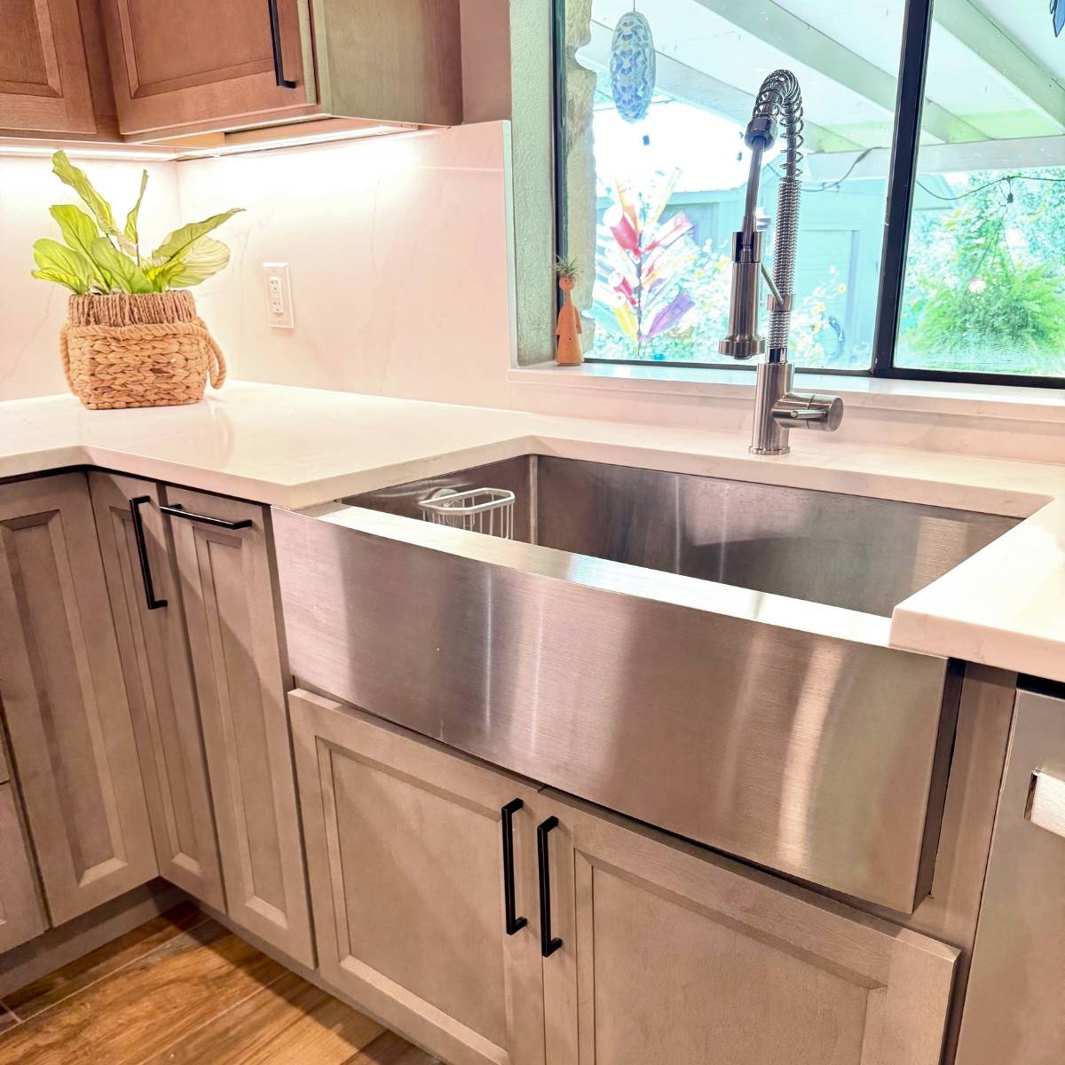 After: Contemporary Austin kitchen by ATX Custom Remodel featuring open layout & stainless steel farmhouse sink