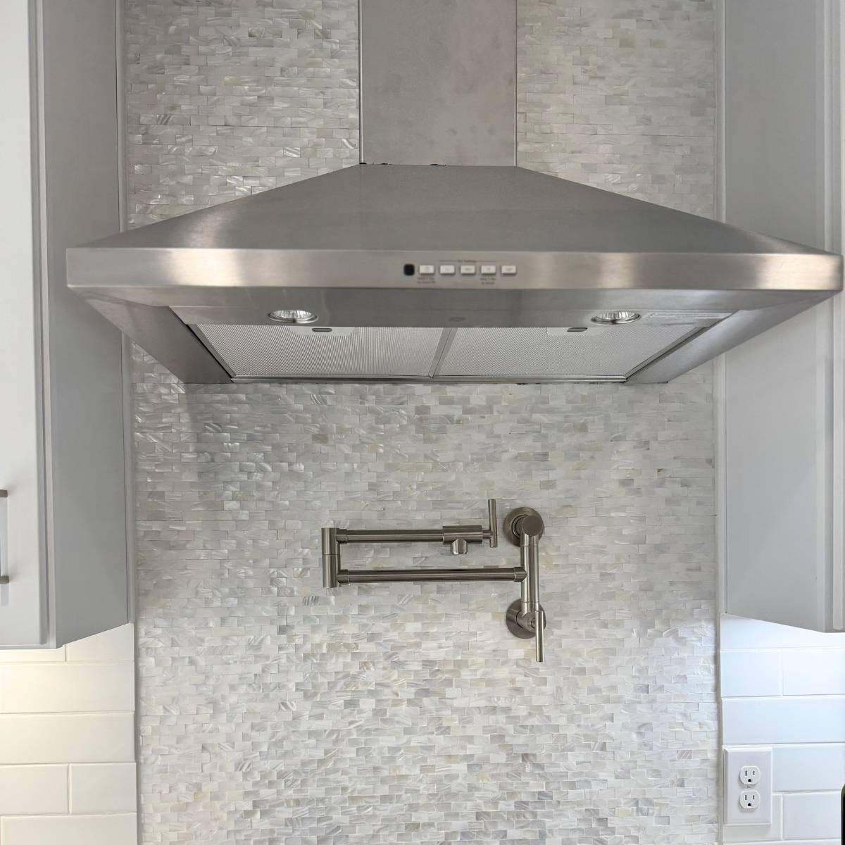 After: Open concept Austin kitchen remodel with stainless appliances and custom backsplash