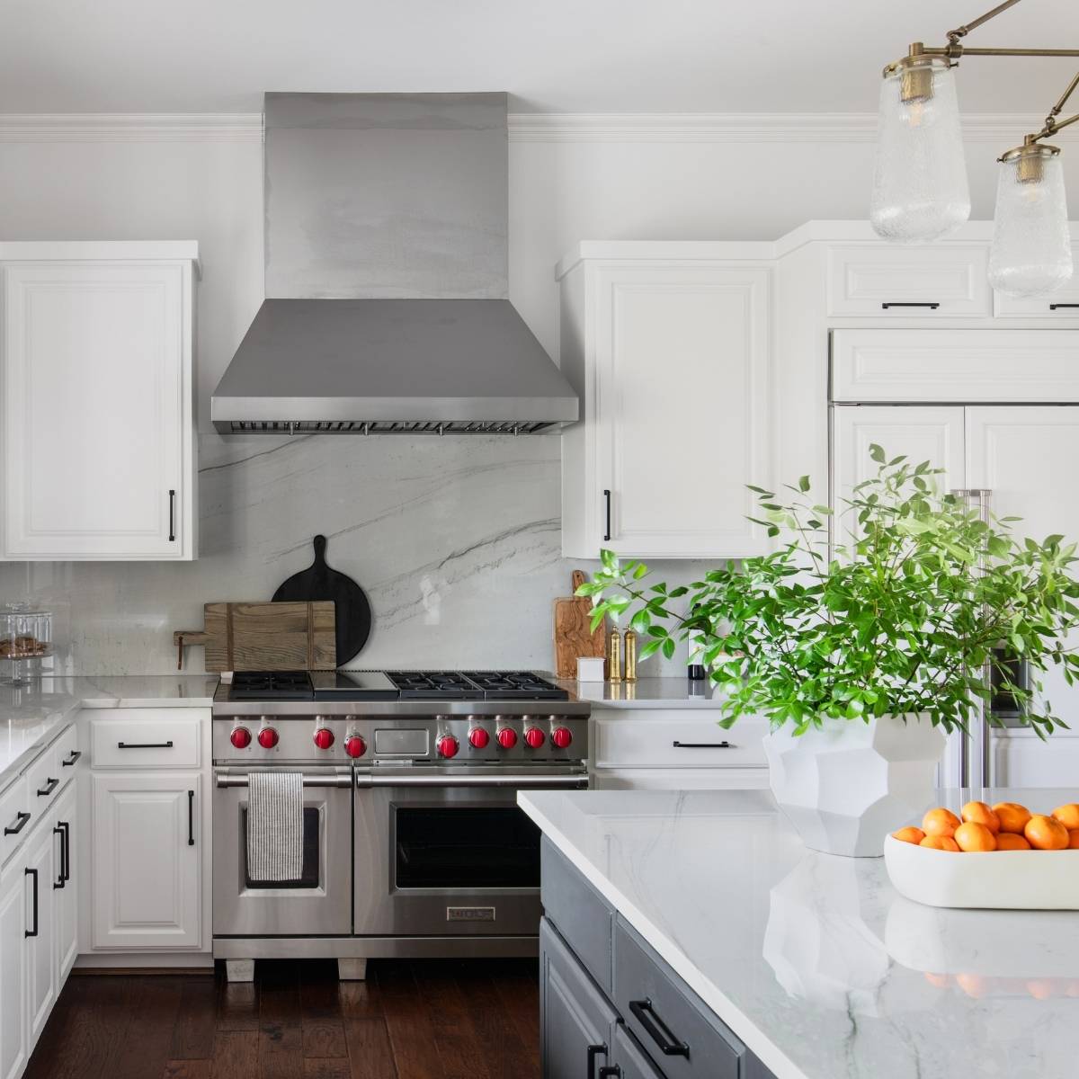 After: Luxury Austin TX kitchen remodel - quartz backsplash, farm sink, and tons of lighting