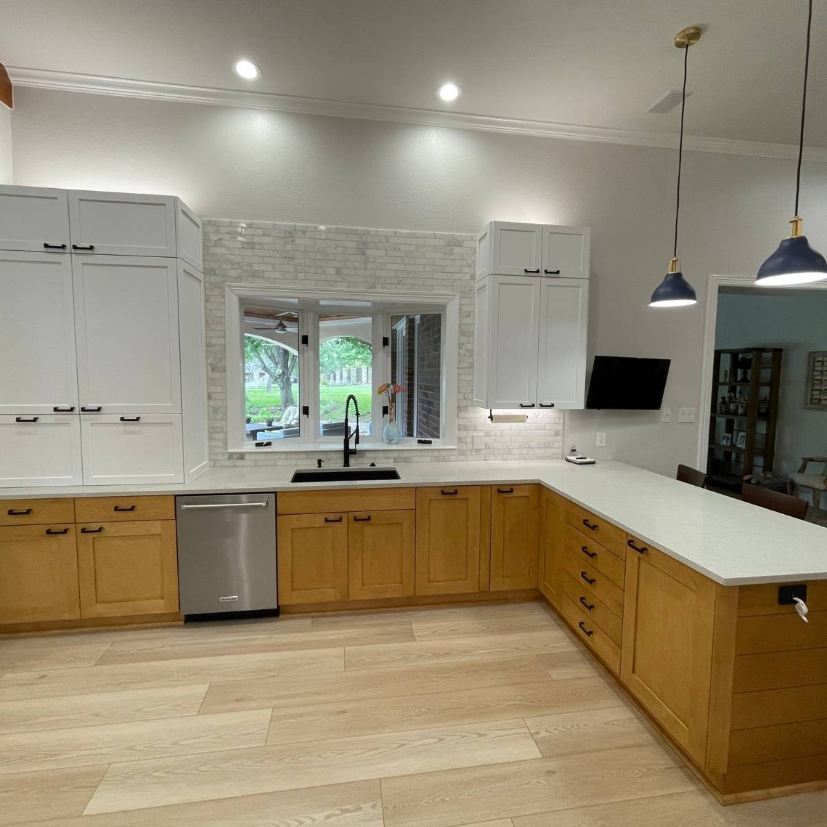 After: Open concept Austin kitchen transformation with quartz counters and stainless appliances