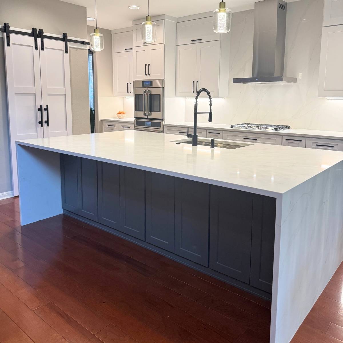 After: Bright modern Austin kitchen renovation - grey cabinets & large island with waterfall countertop