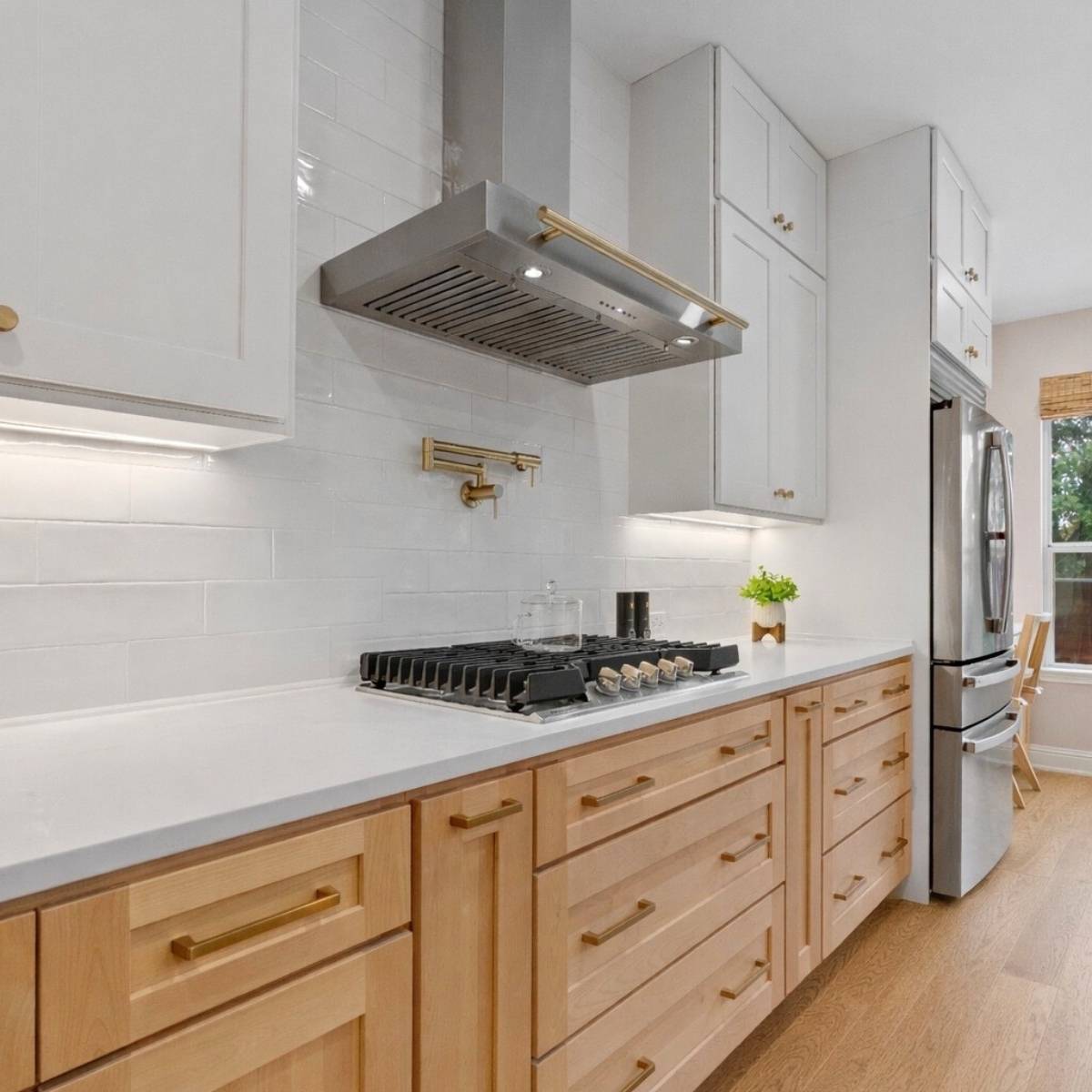 After: Modern Austin kitchen remodel by ATX Custom Remodel - white cabinets and quartz island