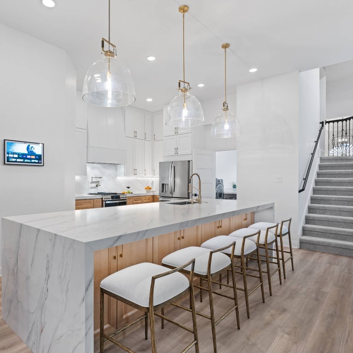 After: Open concept Austin kitchen transformation with waterfall counter island and stainless appliances
