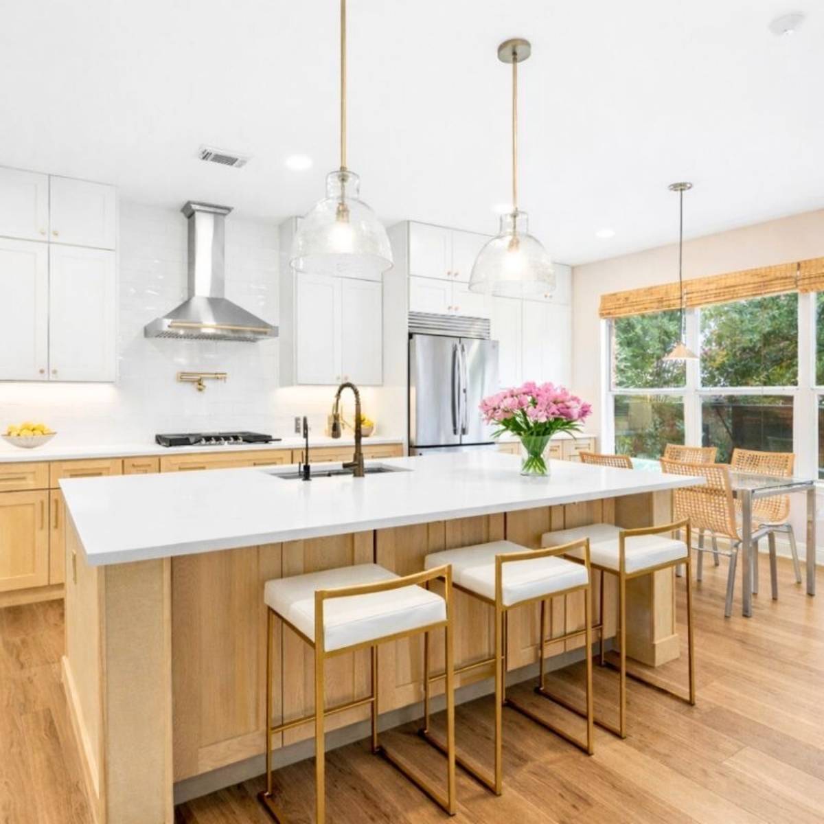 After: Custom Austin TX dream kitchen by ATX Custom Remodel - beautiful island and pendant lights