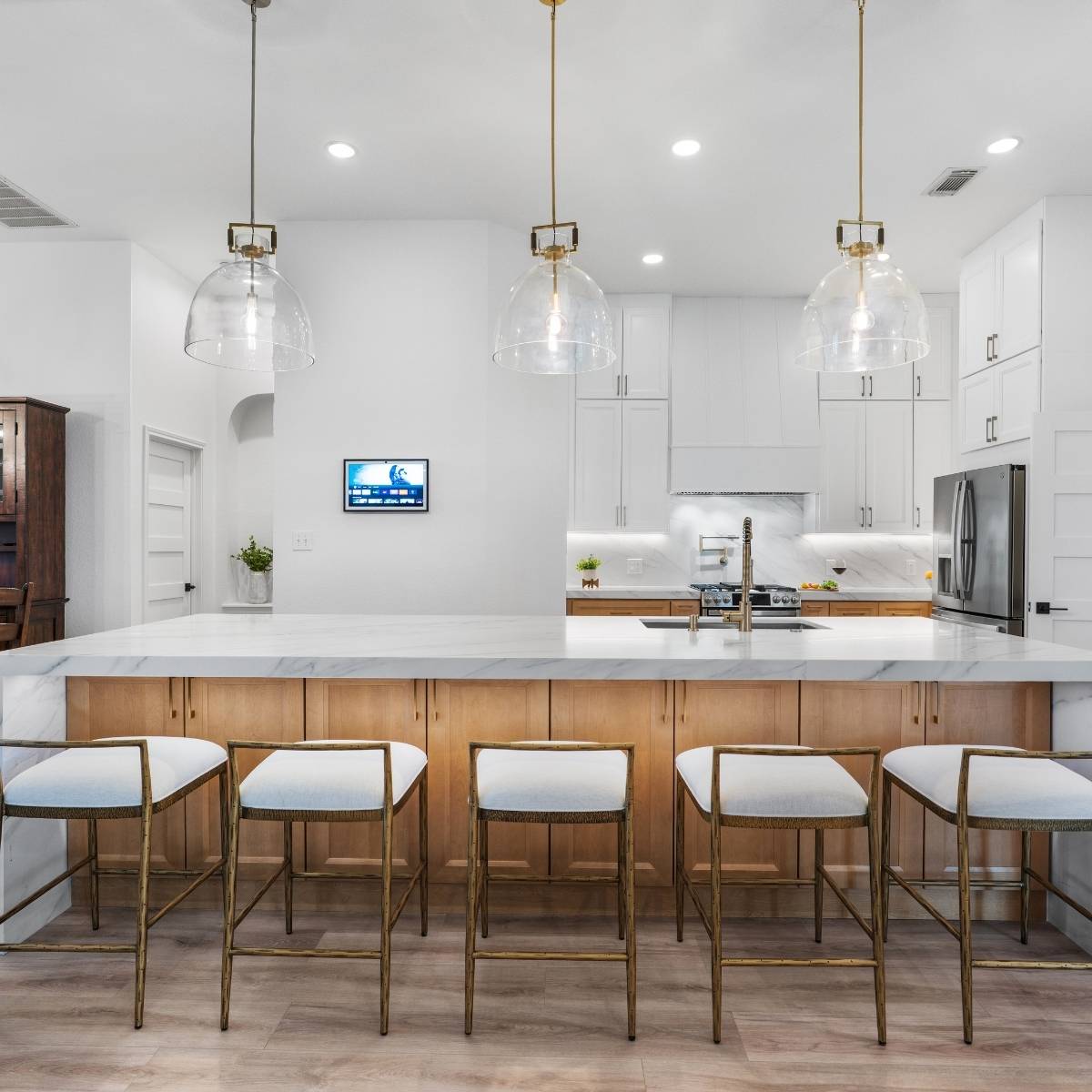 After: Open concept Austin kitchen transformation with waterfall counters and stainless appliances