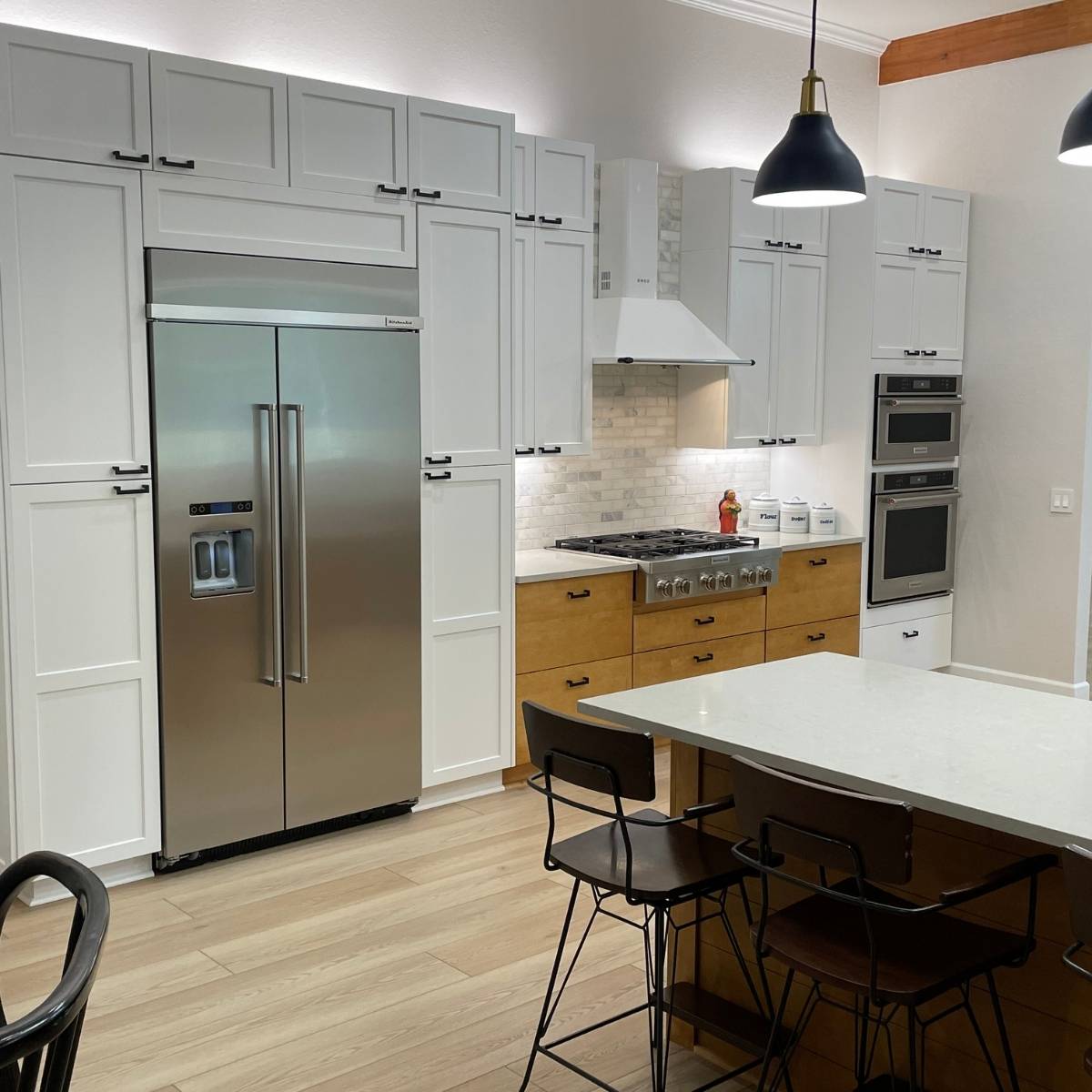 After: Open concept Austin kitchen transformation with a blend of natural wood& white cabinets and stainless appliances
