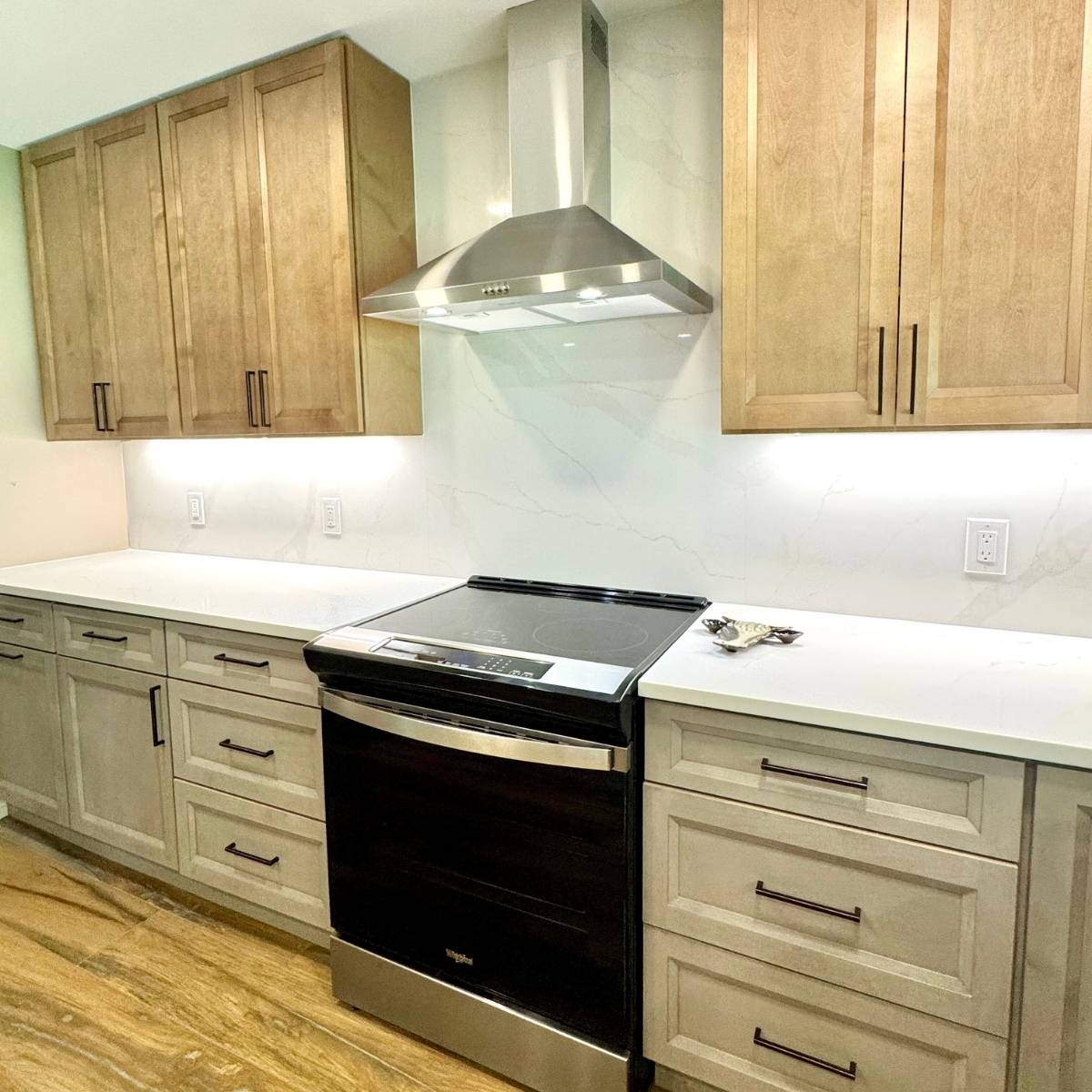 After: Contemporary Austin kitchen by ATX Custom Remodel featuring modern wood canbinets & stainless steel oven hood