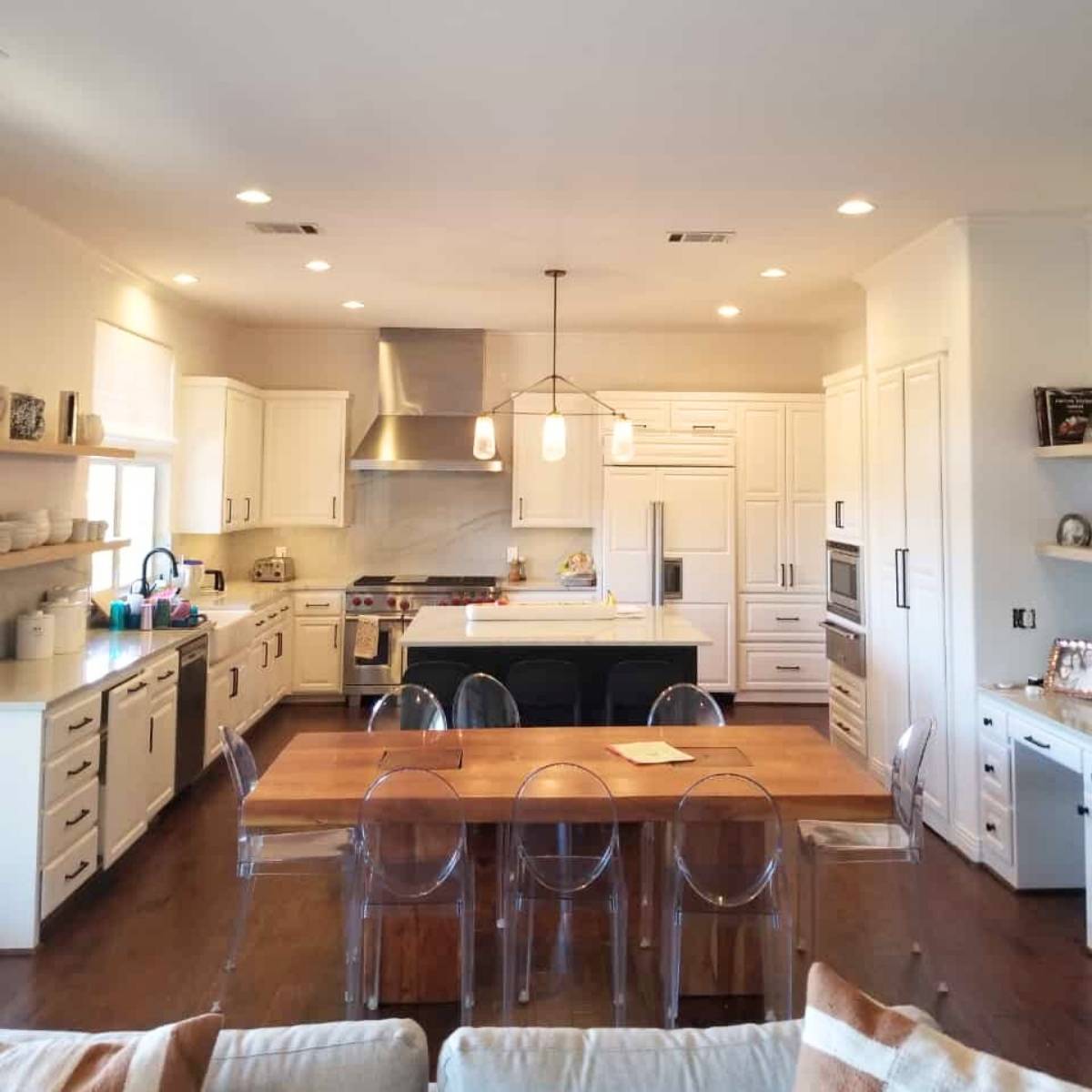 After: Luxury Austin TX kitchen remodel - white cabinetry, farm sink, and LED lighting