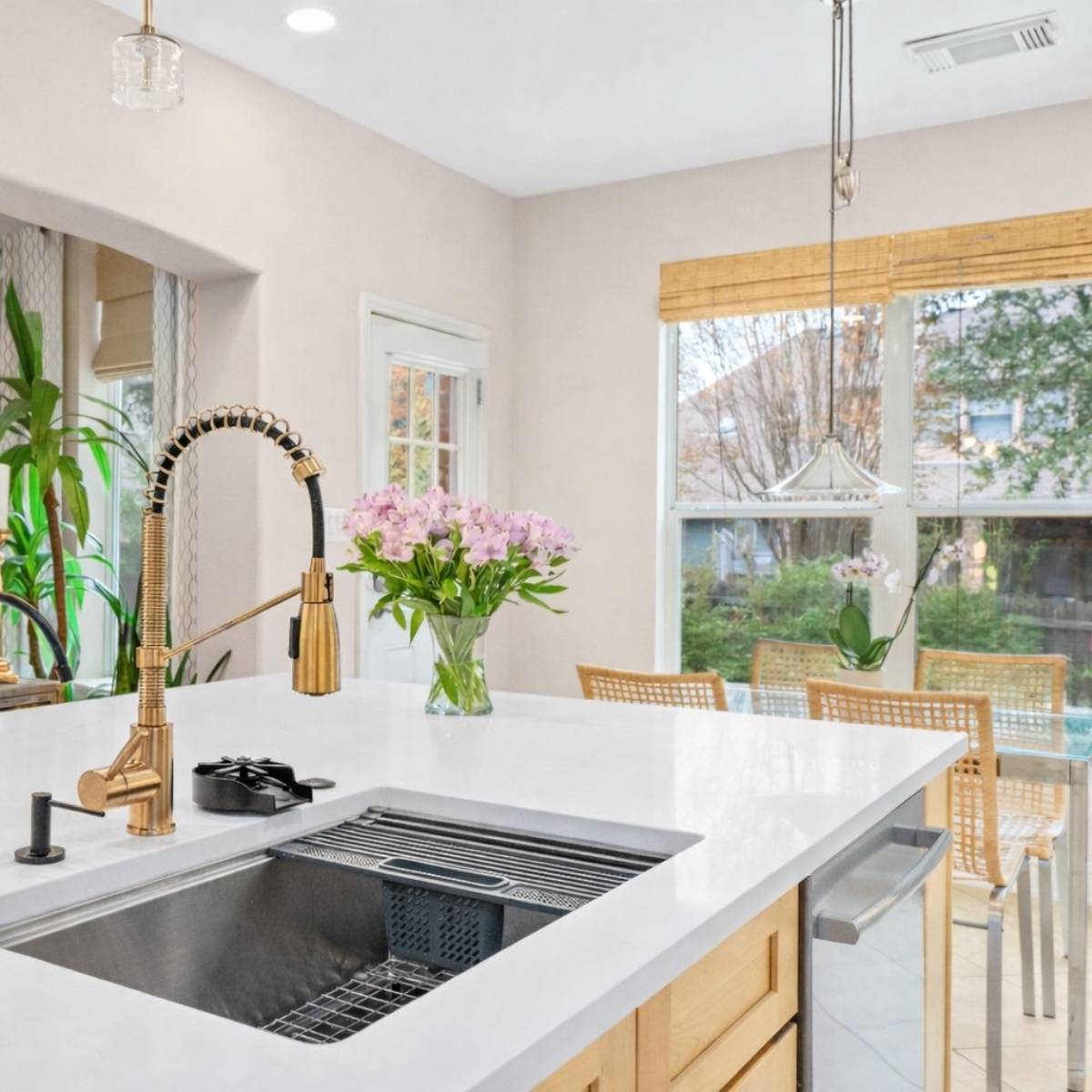 After: Modern Austin kitchen remodel by ATX Custom Remodel - open concept modern kitchen white cabinets and quartz island
