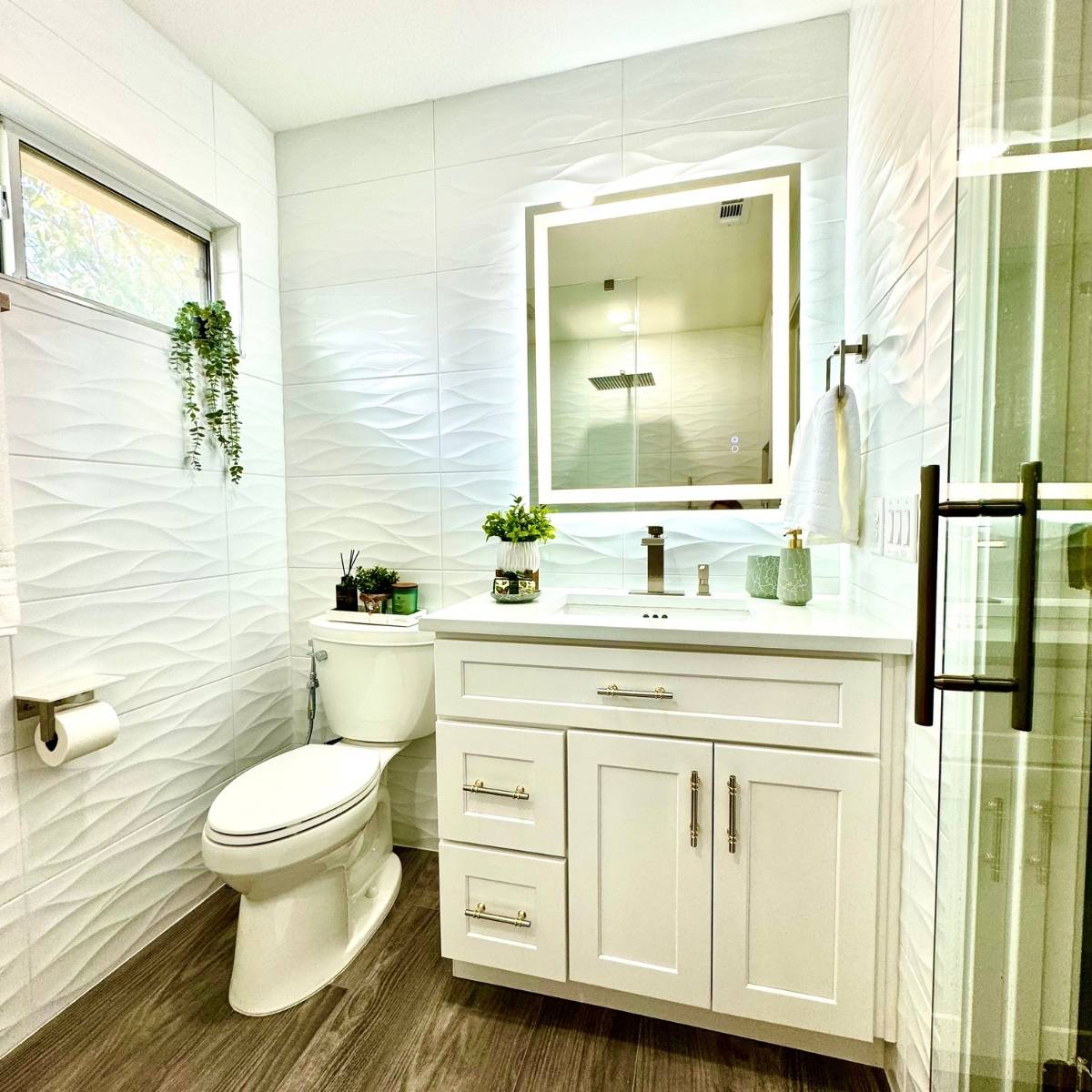 bright spa bathroom renovation Austin Texas with luxury finishes and lit mirror