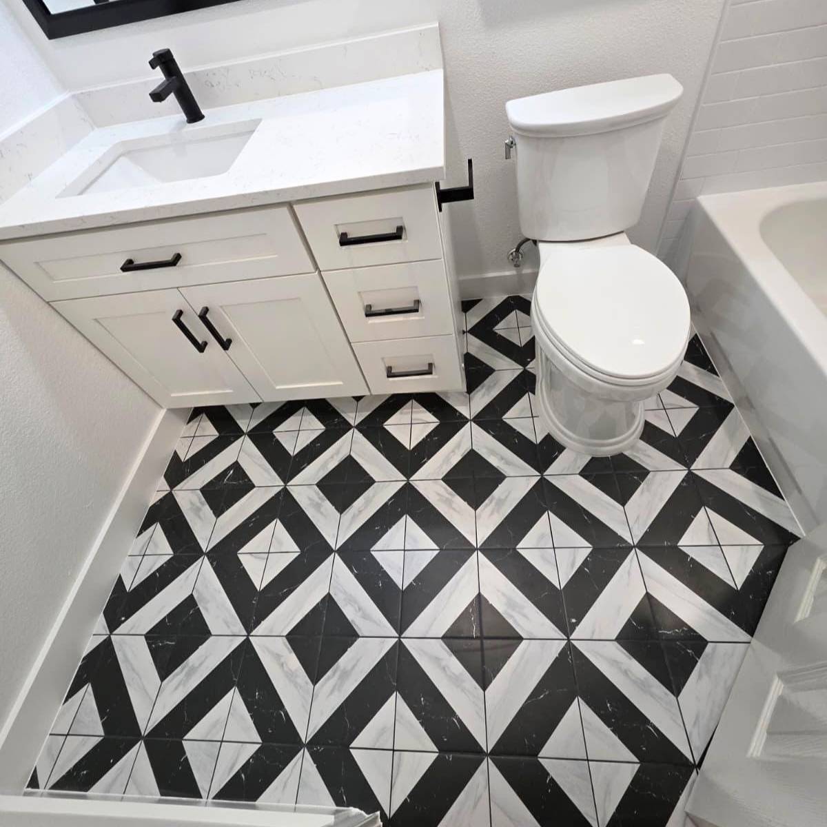 Updated bathroom after remodel with new vanity, mirror, and statement custom tile