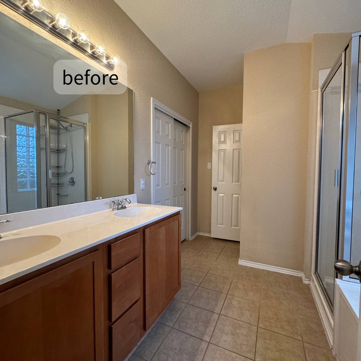 Outdated bathroom before renovation showing basic dark cabinets and basic countertop