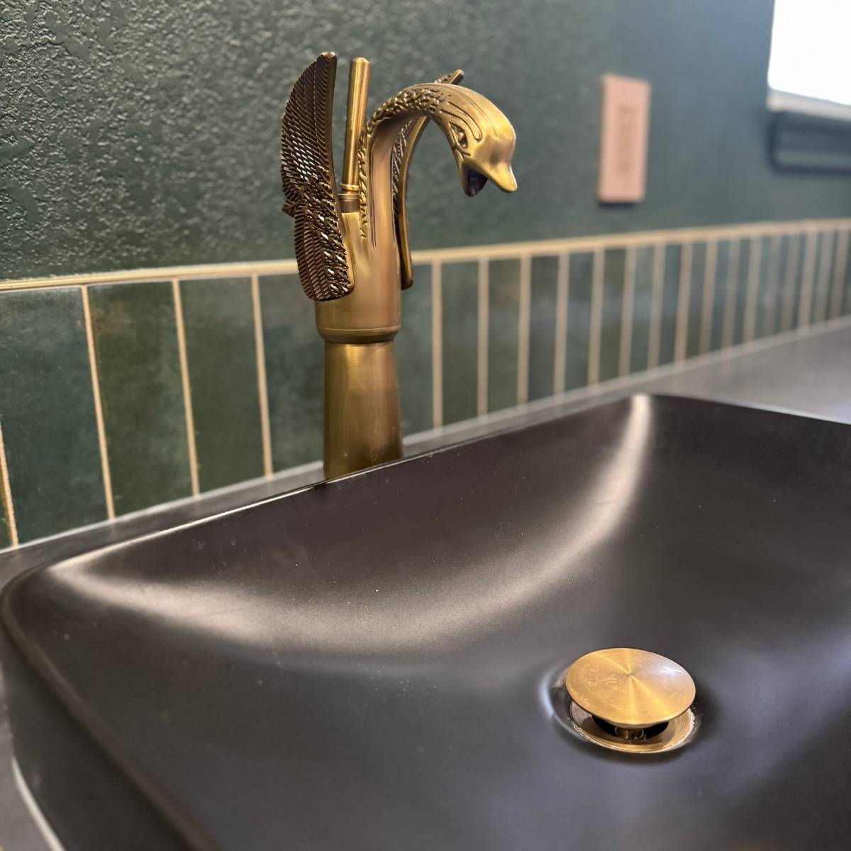 After: Modern brass & gold custom bathroom fixture after remodel with custom green tile in Austin