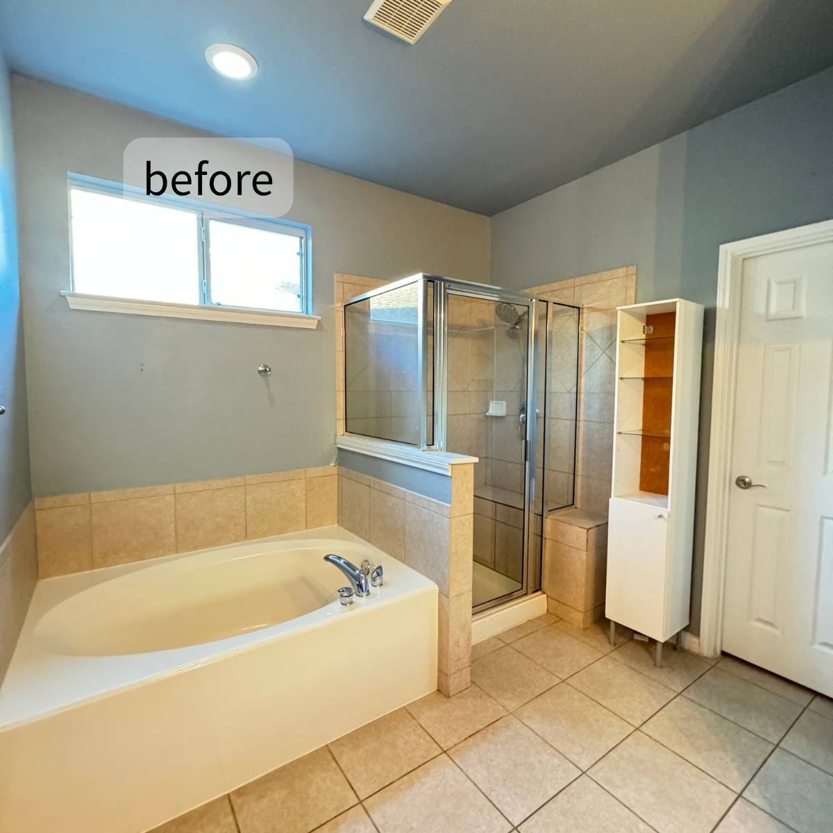 Outdated bathroom before full remodel showing old flooring and basic cabinets