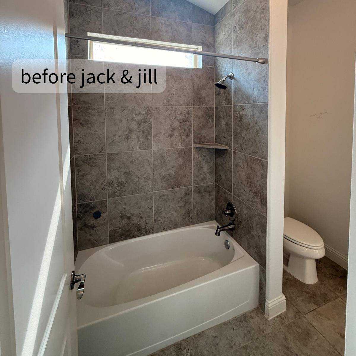 Dark Jack & Jill bathroom with tub before remodel with split wall in Austin