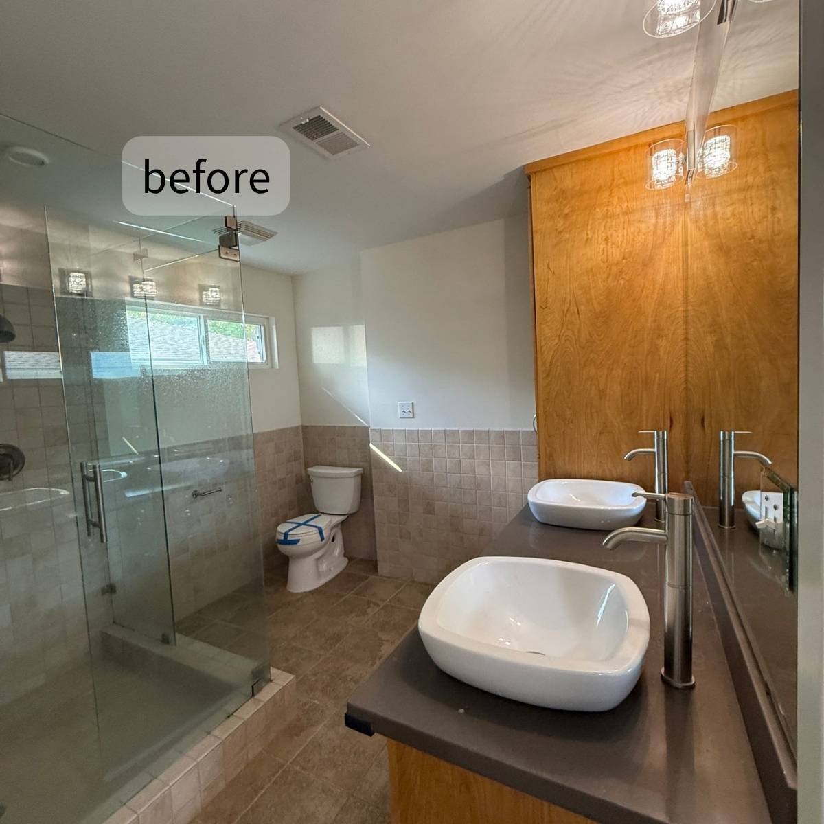outdated bathroom with wood cabinets and old countertops before redesign 