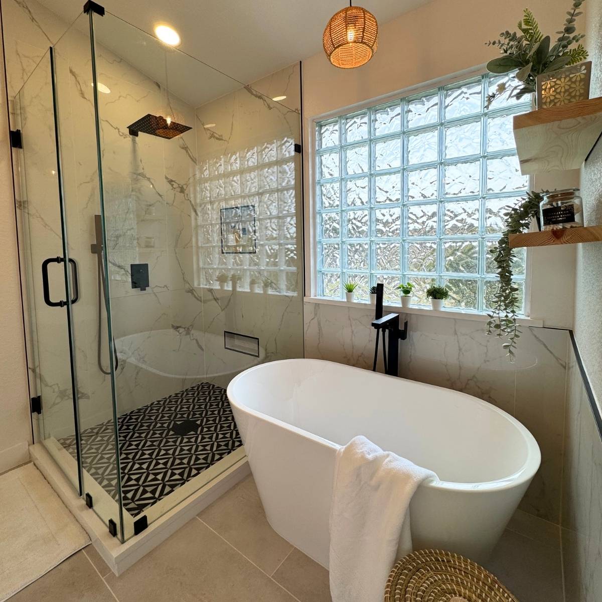  Luxury primary bathroom after renovation with freestanding tub and walk-in shower and statement lighting
