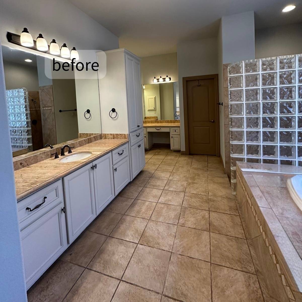 Outdated bathroom before full remodel showing old flooring and counters and basic mirror