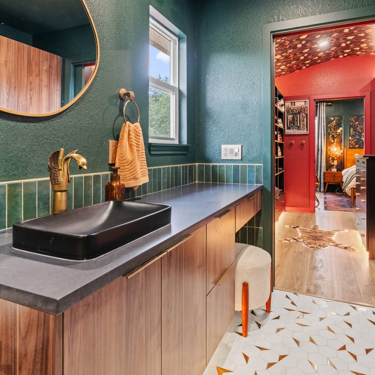 After: Stunning dramatic primary bathrooml with new vanity, statement mirror, and bold flooring