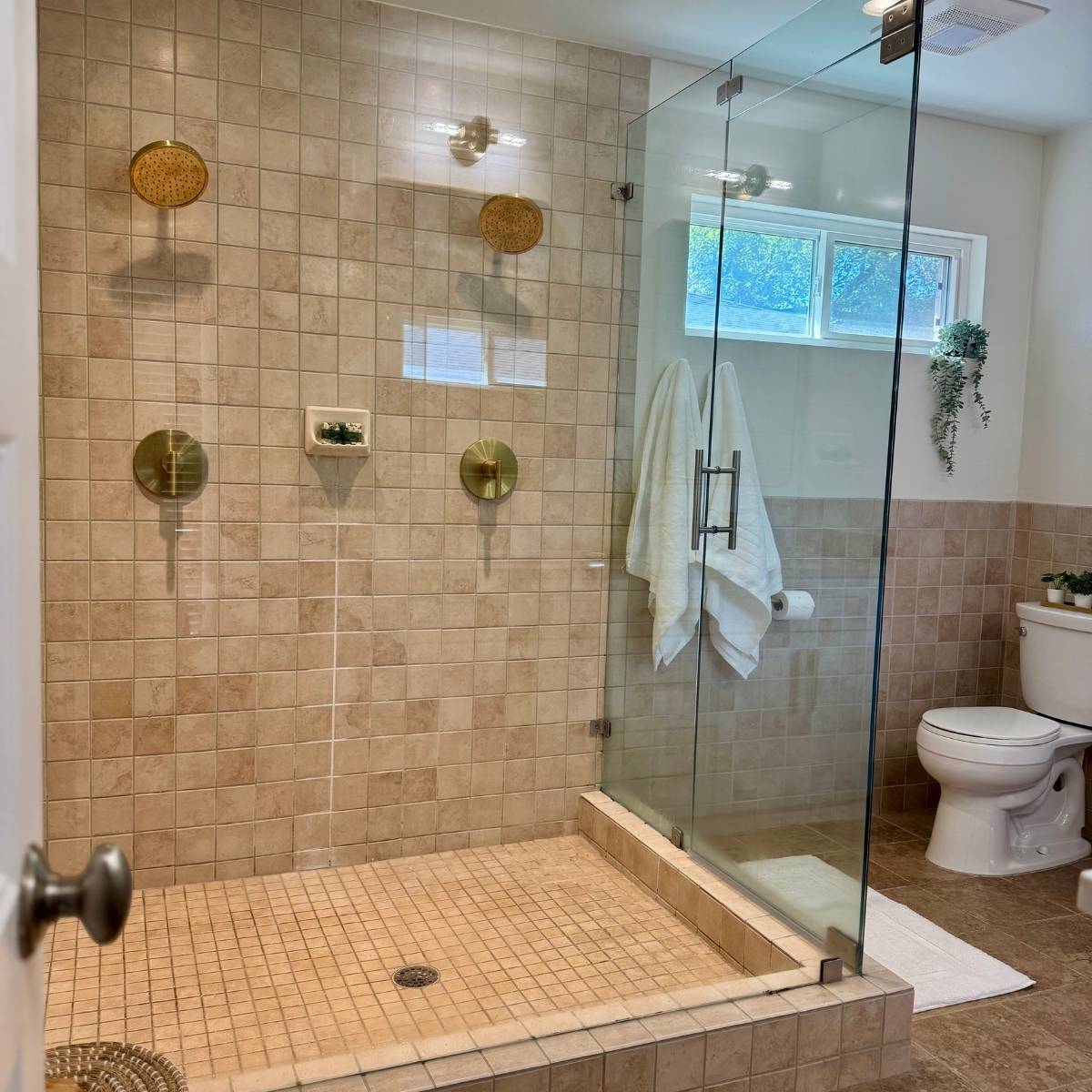 Modern bathroom after remodel with double vanity and quartz countertops in Austin