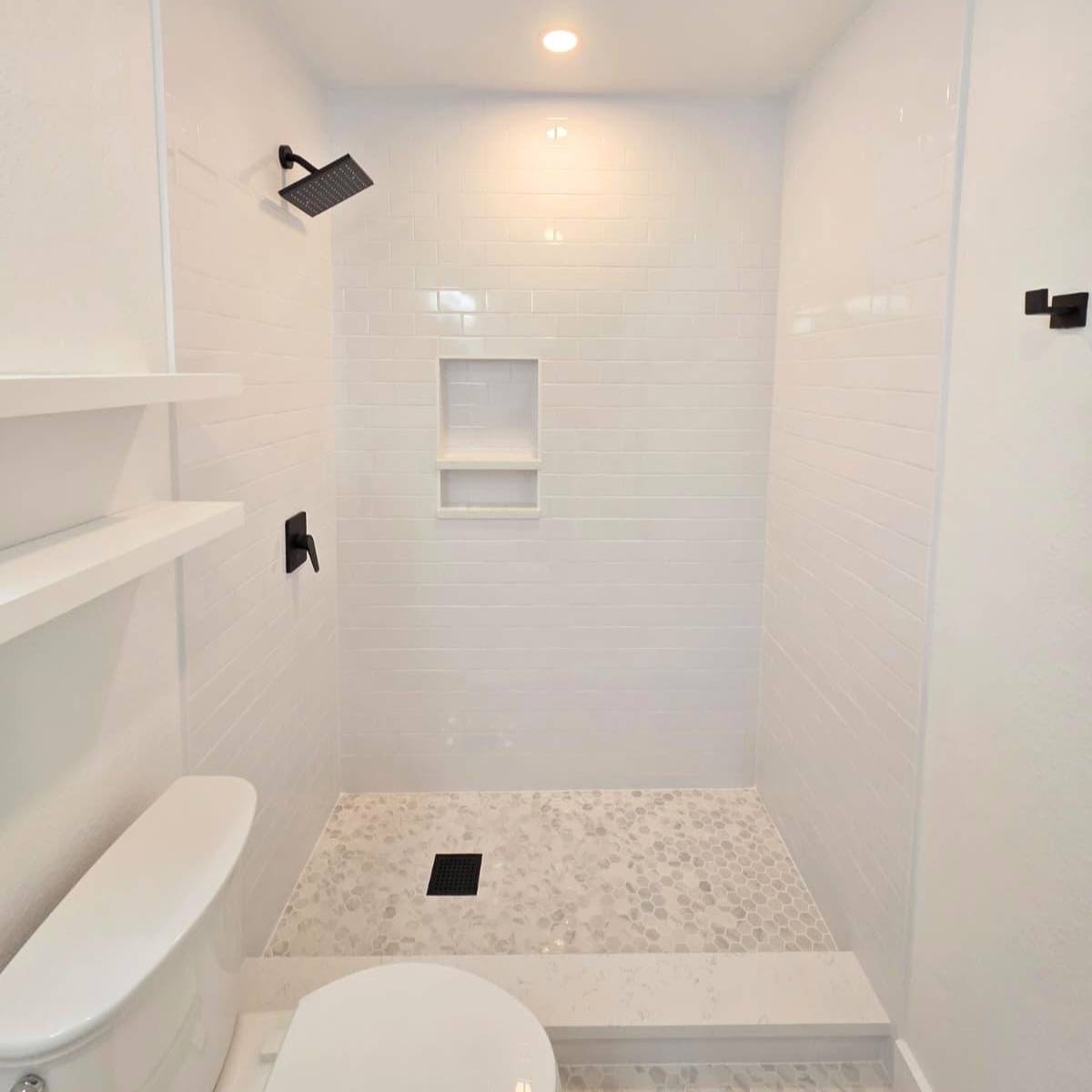 Bright bathroom after makeover with bright custom tile shower