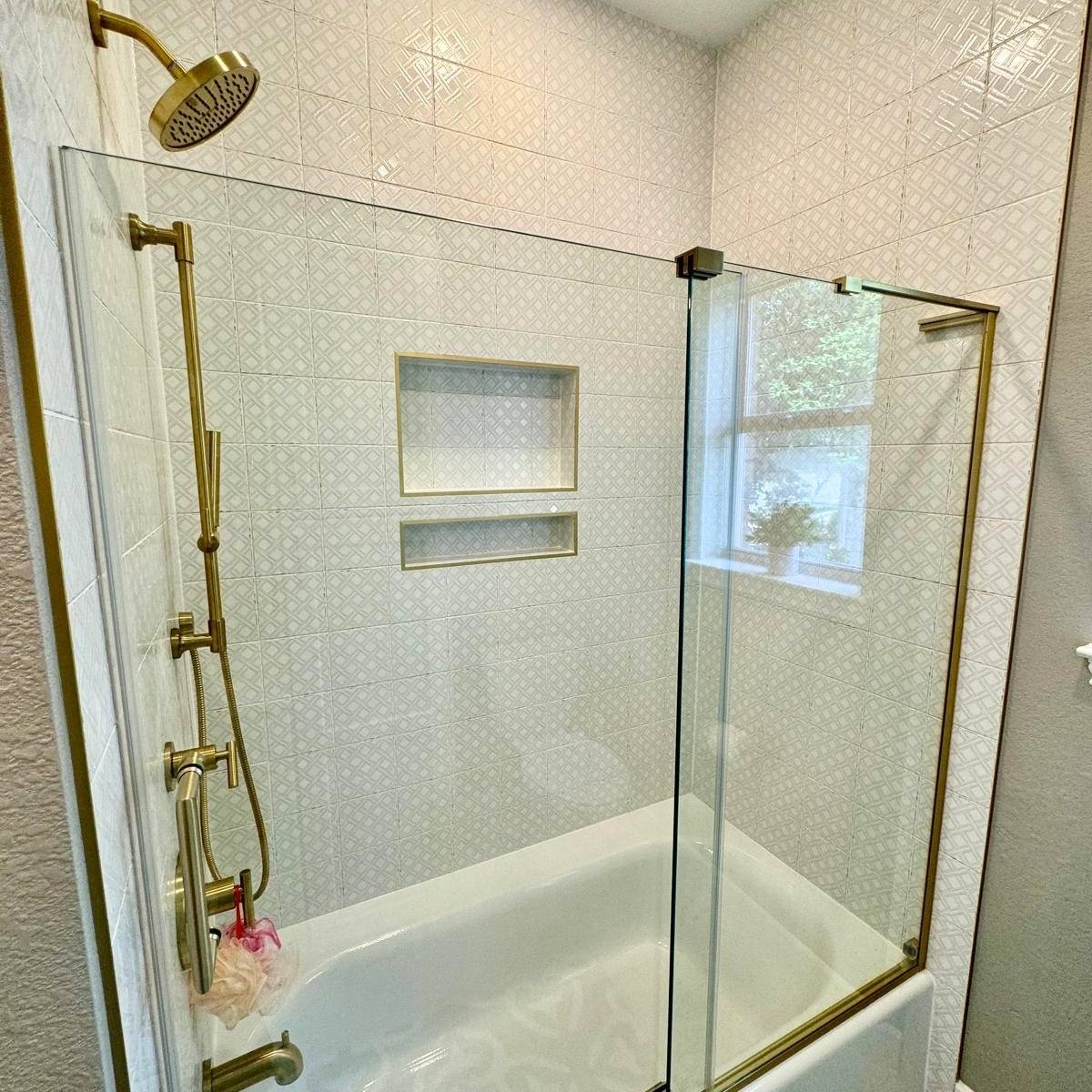 Bright bathroom after Jack & Jill makeover with custom tile shower and gold fixtures in Austin