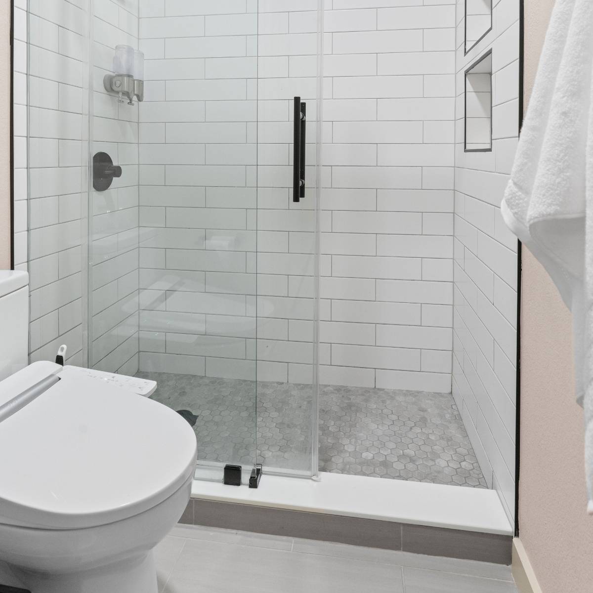 Spacious walk-in shower after bathroom renovation with frameless glass 