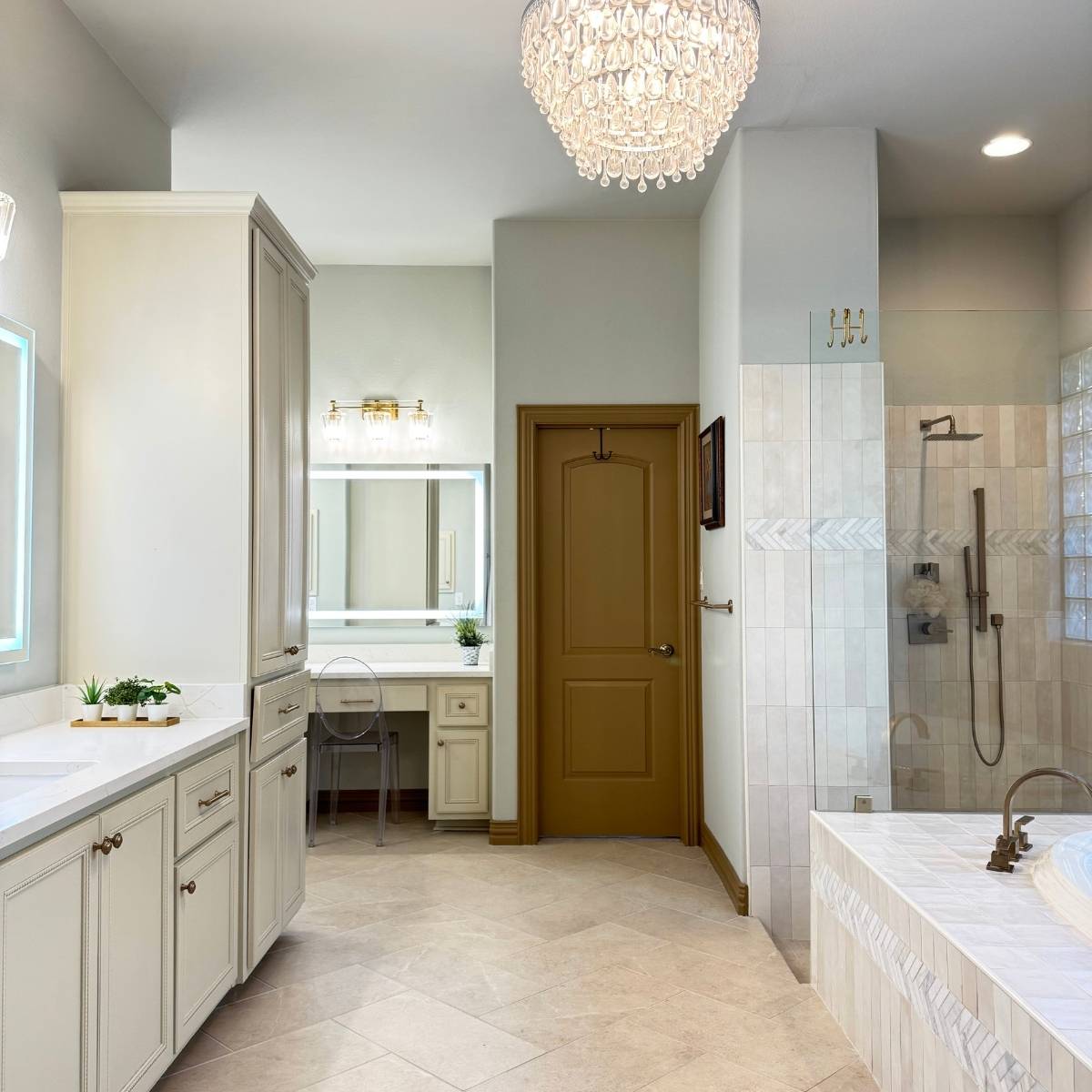 Luxury primary bathroom after renovation with custom tile, walk-in shower & chandelier