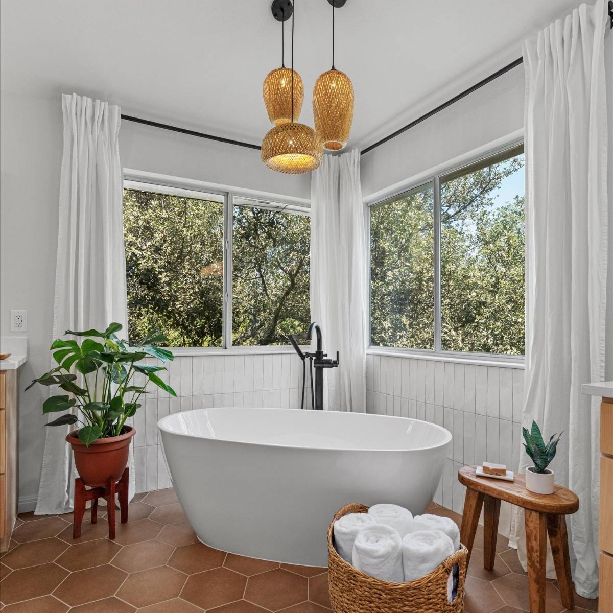  Bright bathroom after renvovation with new free-standing tub and statement lighting in Austin