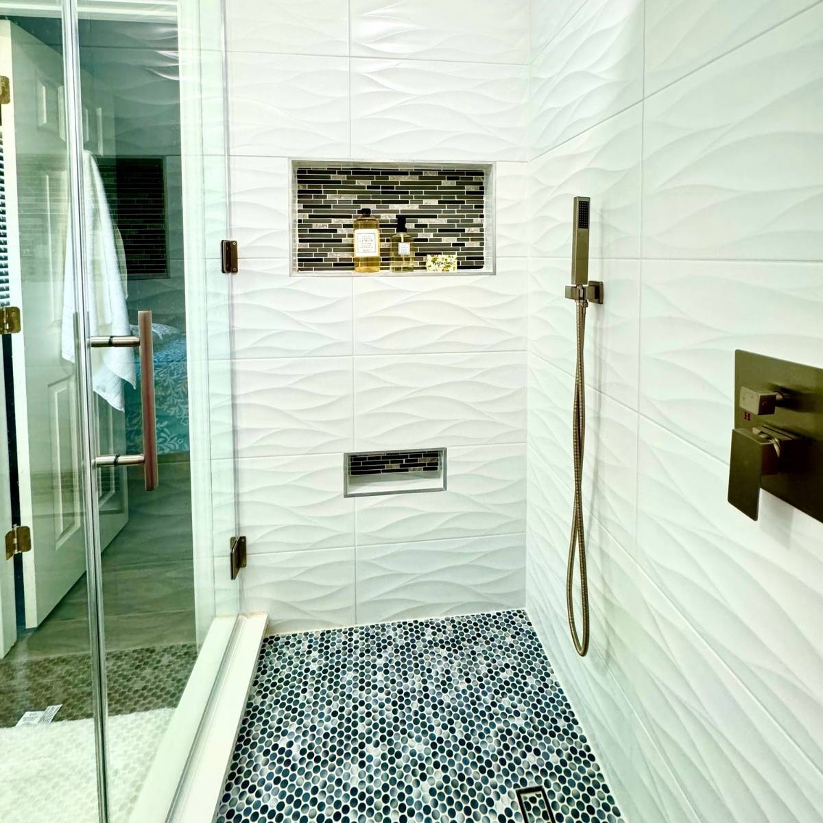 contemporary bathroom renovation Austin Texas with frameless glass shower with custom tile & shower niche