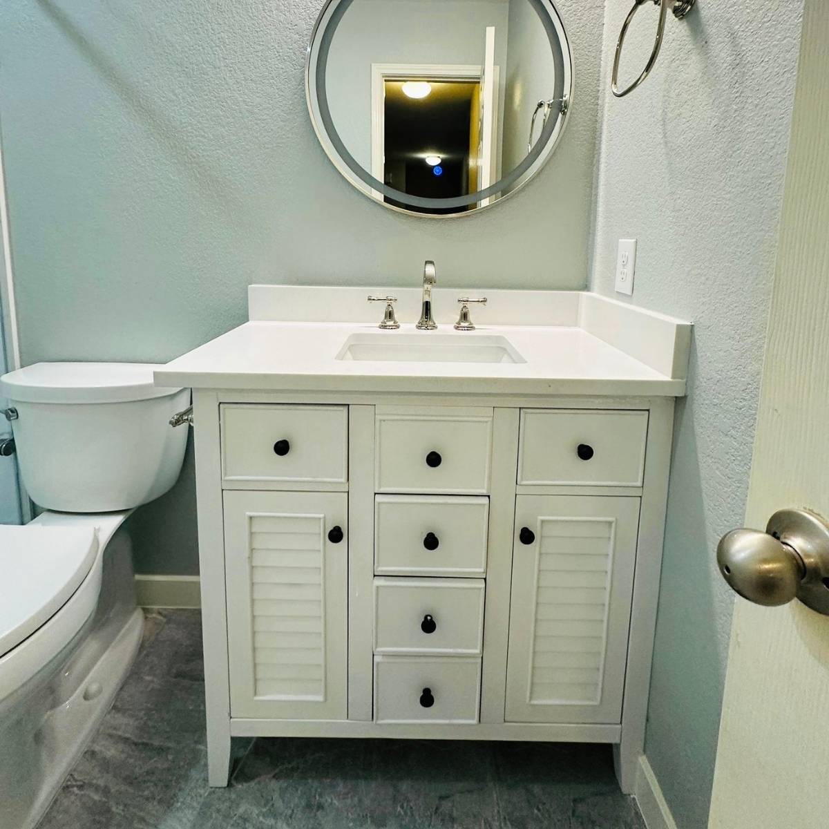 Austin updated bathroom after remodel with new vanity, mirror, and lighting