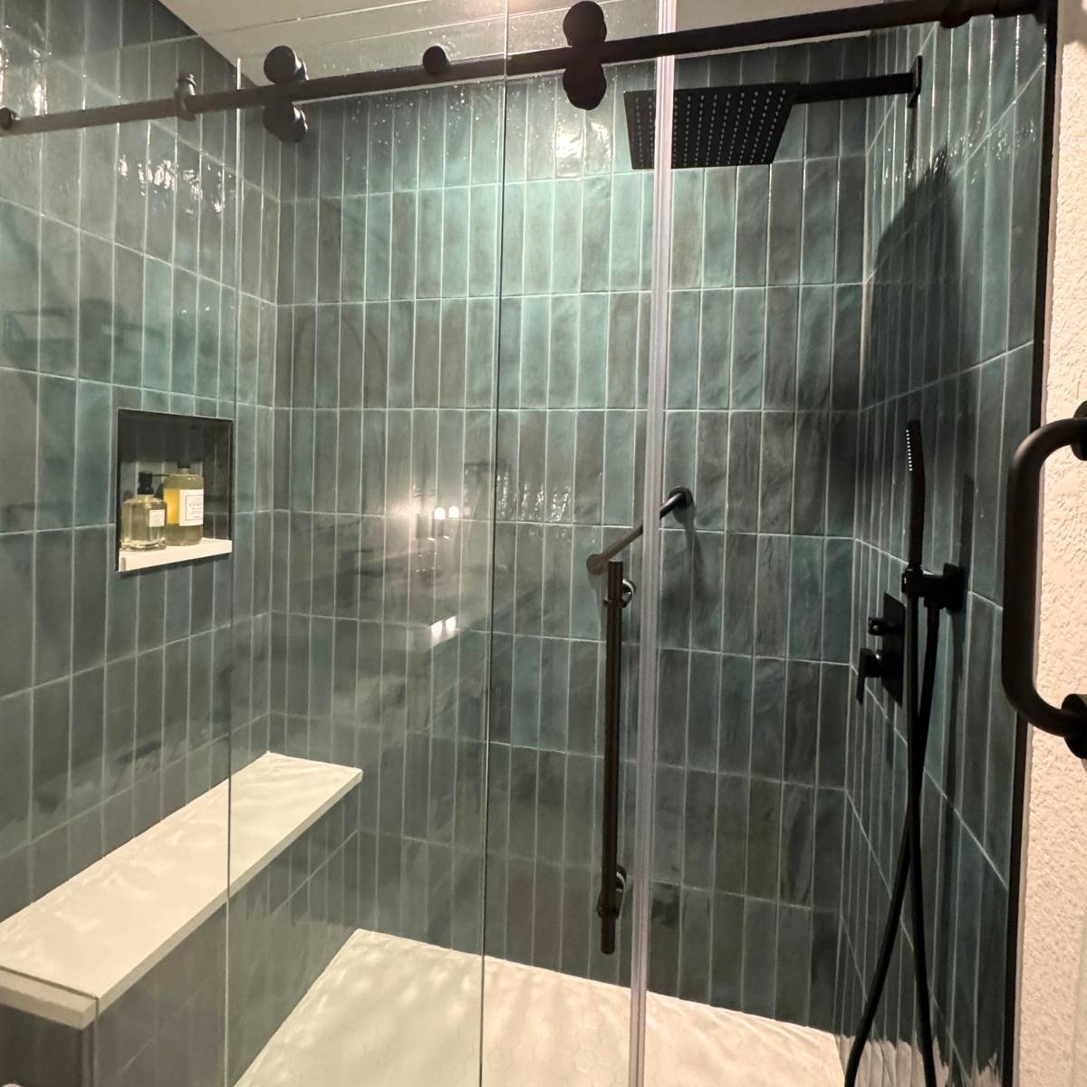 modern bathroom remodel in Austin TX with walk in green custom tile shower and glass door