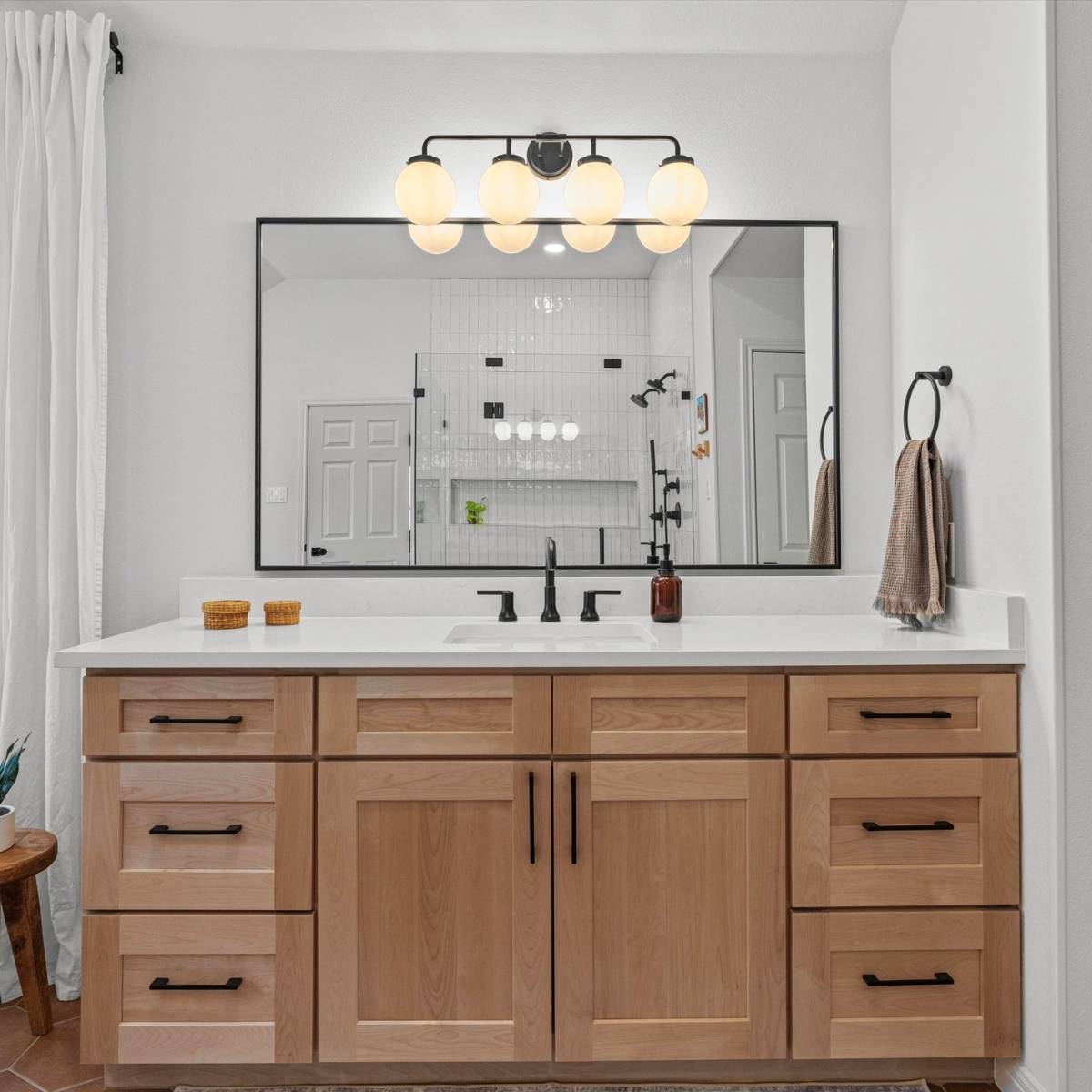 custom wood vanity after primary bath remodel with new black fixtures in Austin