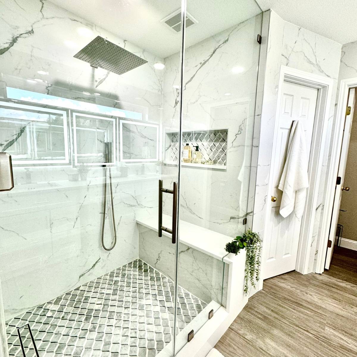 contemporary bright bathroom remodel in Austin Texas with frameless glass shower & custom bench