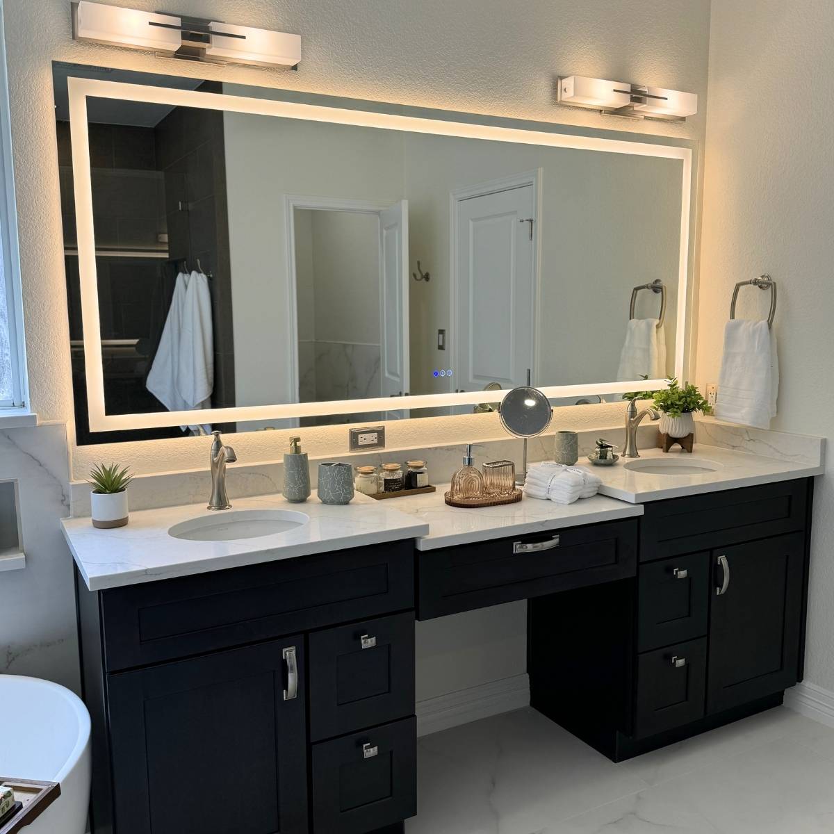 elegant bathroom remodel Austin TX with custom vanity and lit up mirrors